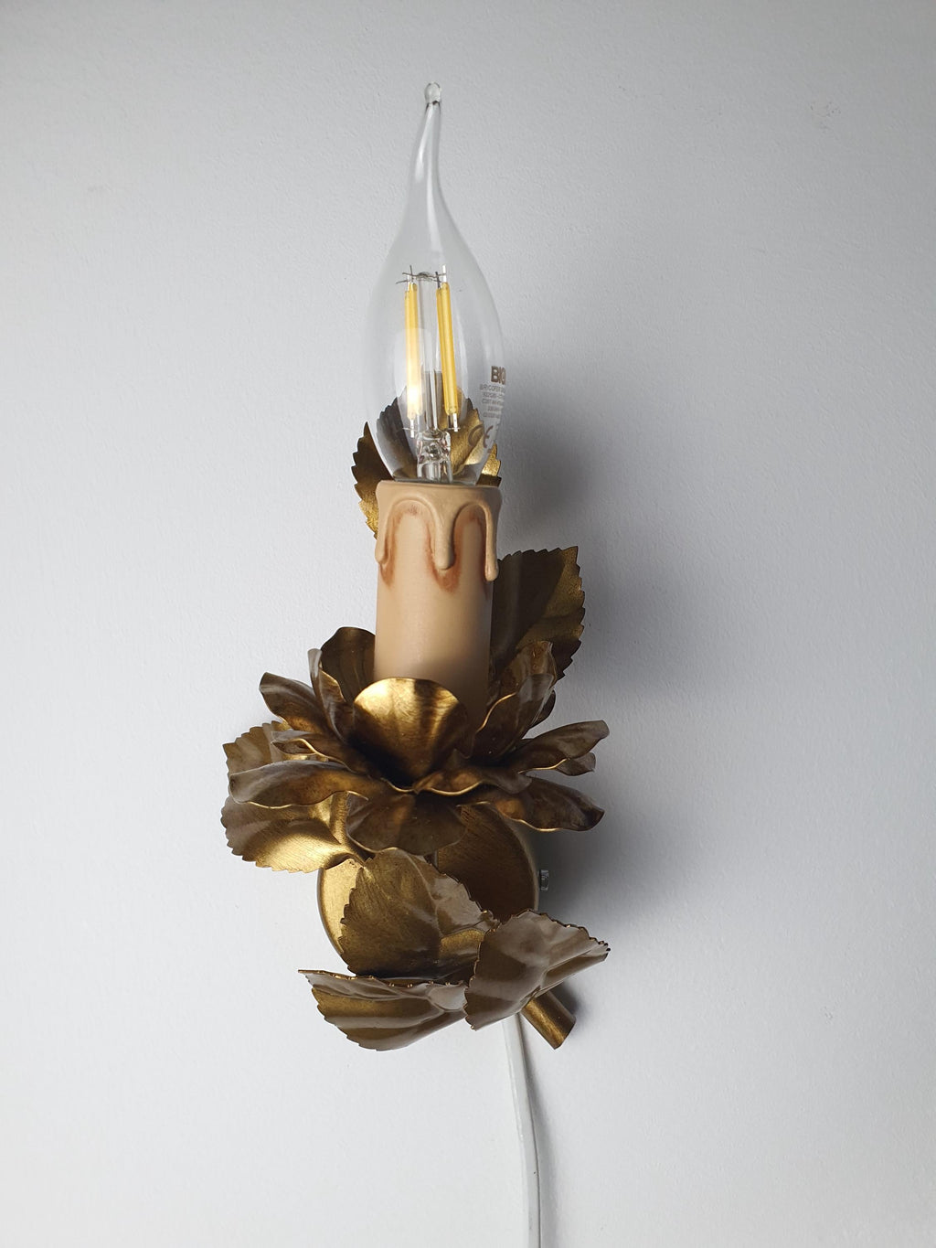 Smaller floral wall sconce with one candle-style light holder
