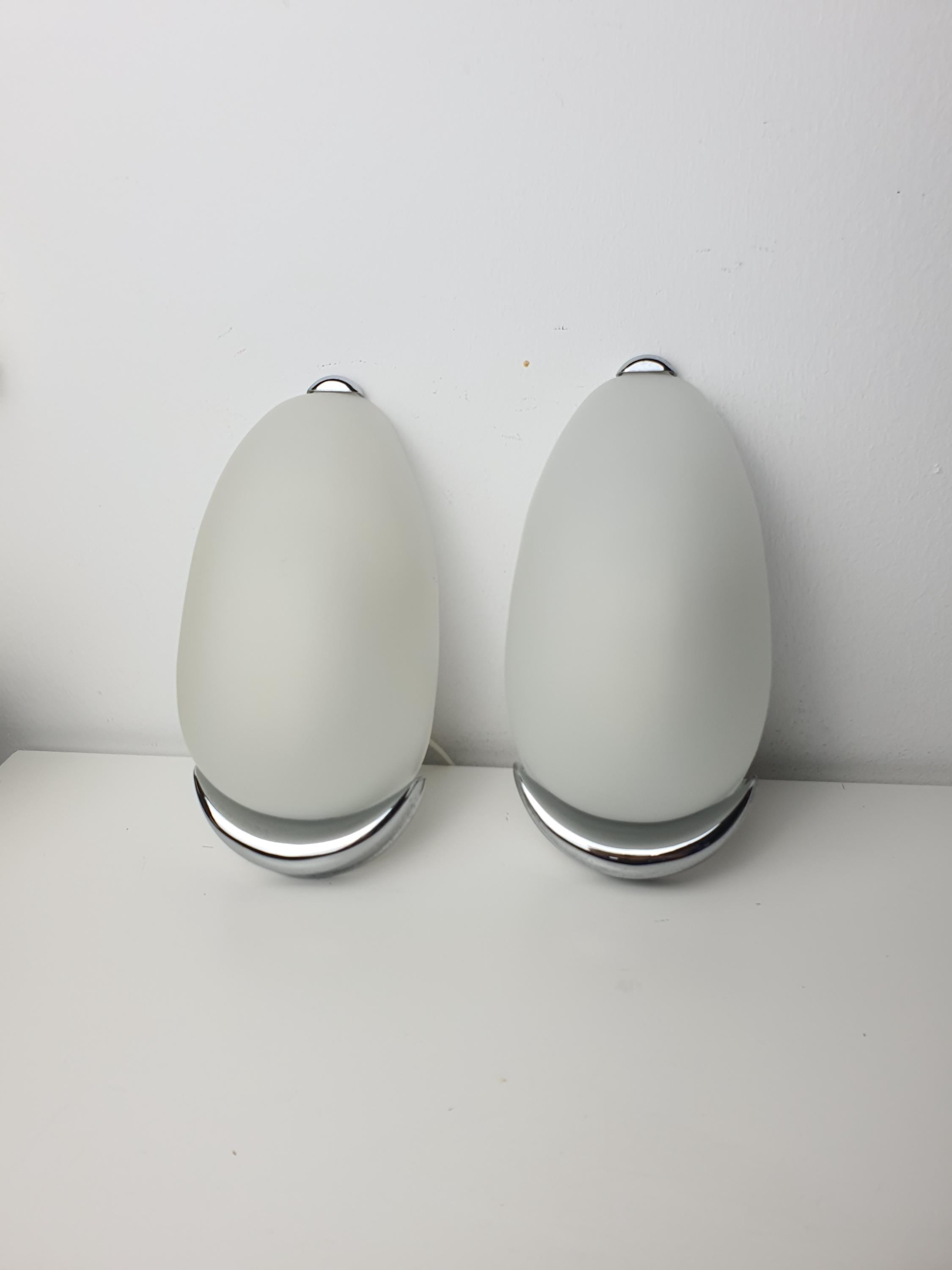 Pair of Italian egg-form sconces in hallway, satin frosted glass capsule shades, balanced symmetrical installation