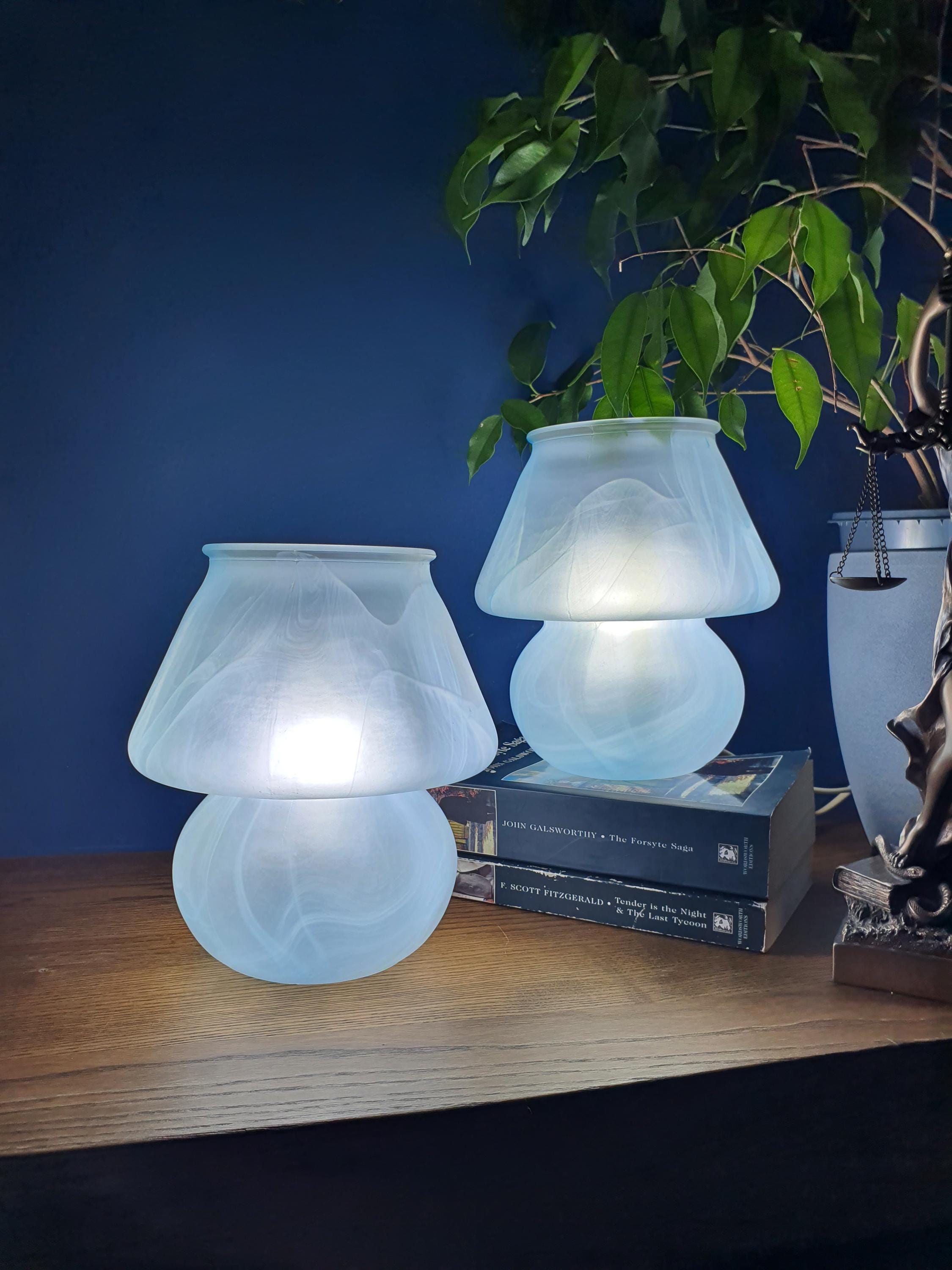 Pair of vintage Due P. Murano mushroom lamps lit, warm soft glow through satin frosted glass, blue marbled wave, bedside setting