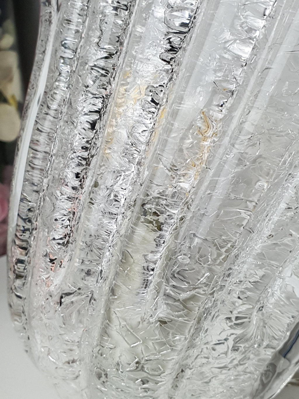 Thick clear glass shade with a sculptural floral silhouette
