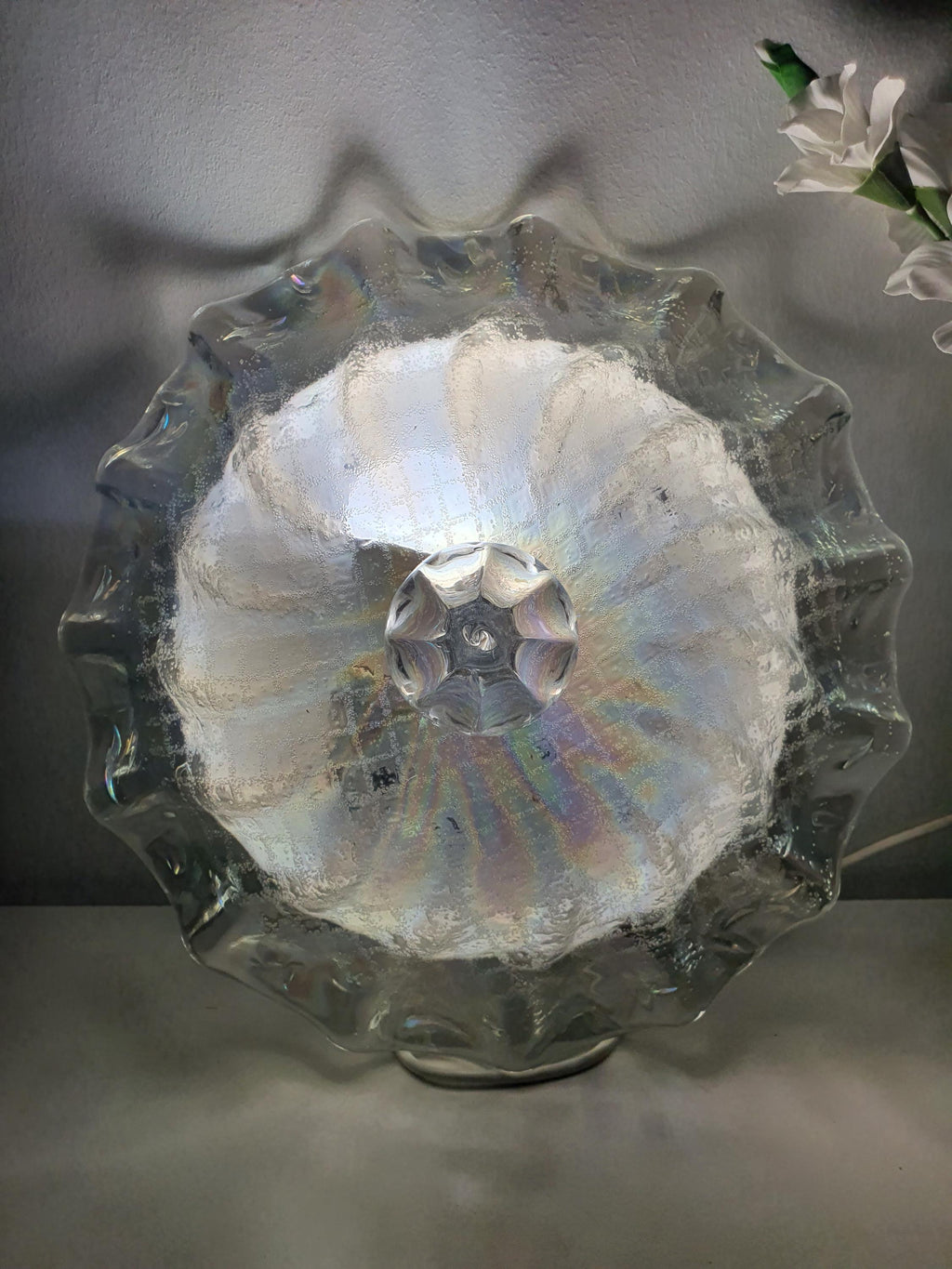Sculptural glass contours inspired by seashell curves and flower petals
