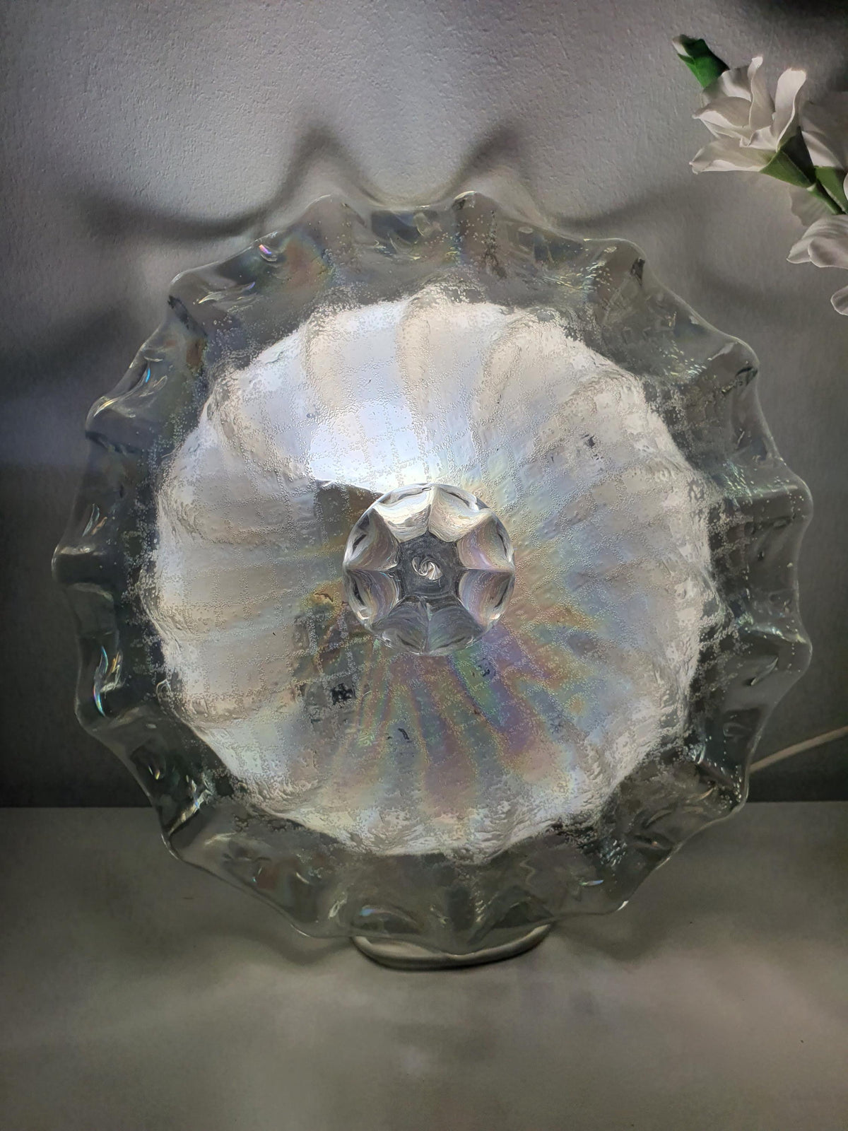 Sculptural glass contours inspired by seashell curves and flower petals
