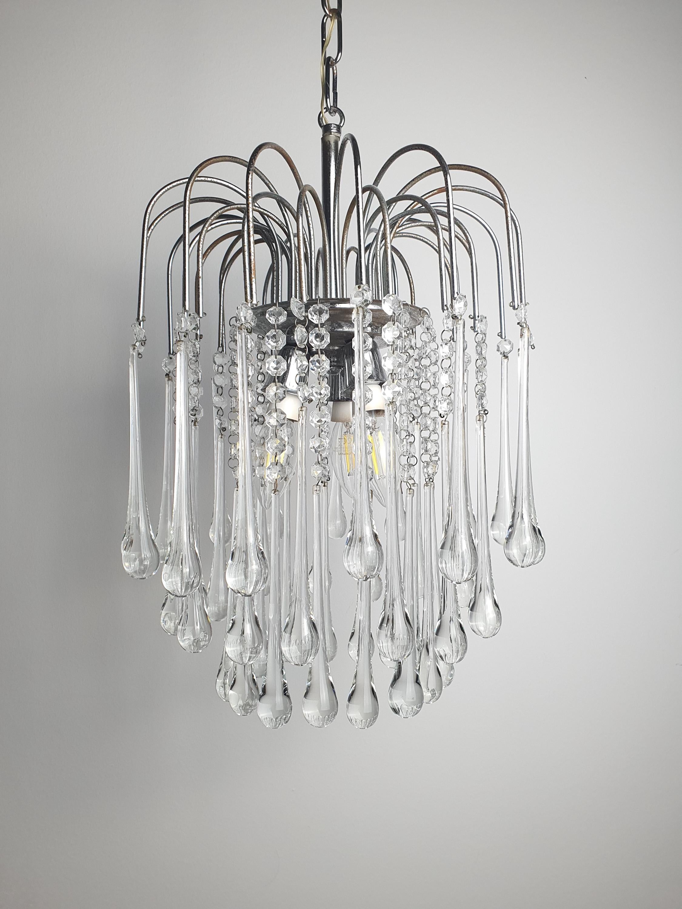 Vintage Murano clear teardrop cascade chandelier in bedroom, sparkling waterfall drops, chrome frame, Hollywood Regency