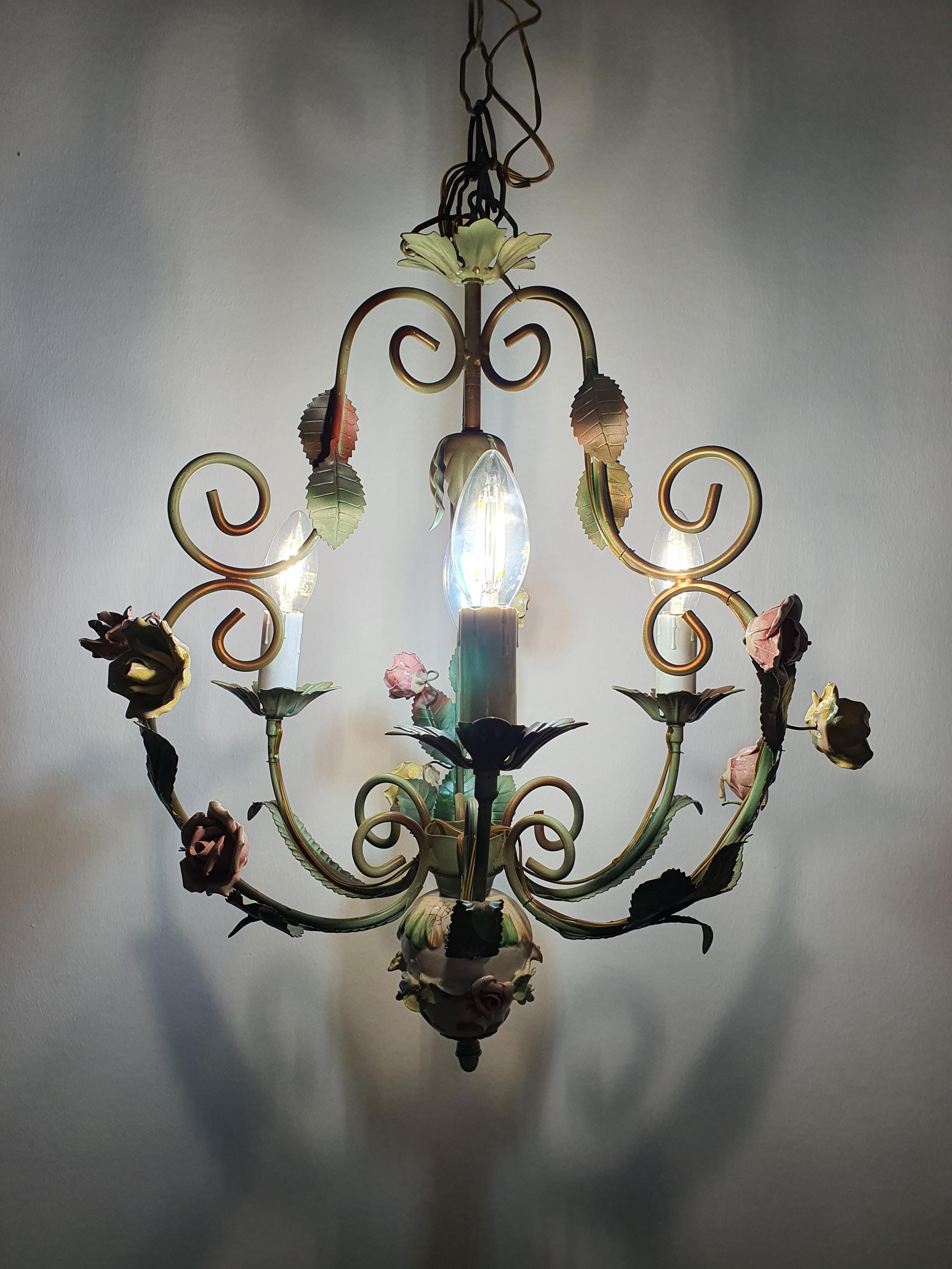 Detail of paint patina and color loss on green toleware arm, vintage 1950s Italian chandelier