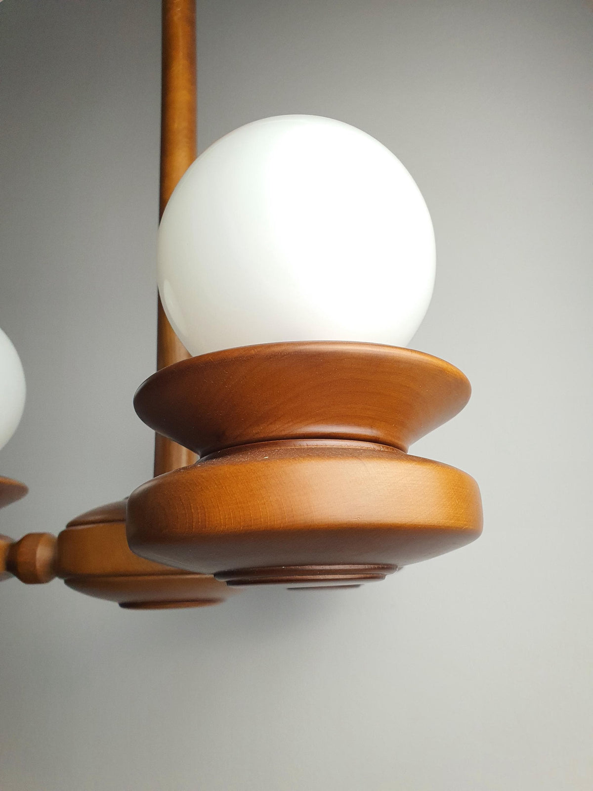 Close-up of milk glass globe shade on vintage Space Age Sputnik chandelier, soft even ambient diffusion, beautifully preserved