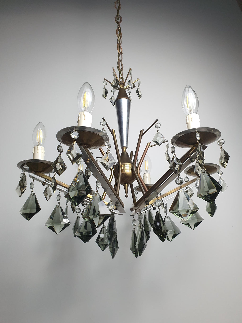 Art Deco 6-arm chandelier side profile, tree-branching brass chrome structure with smoky grey crystal drop cascade