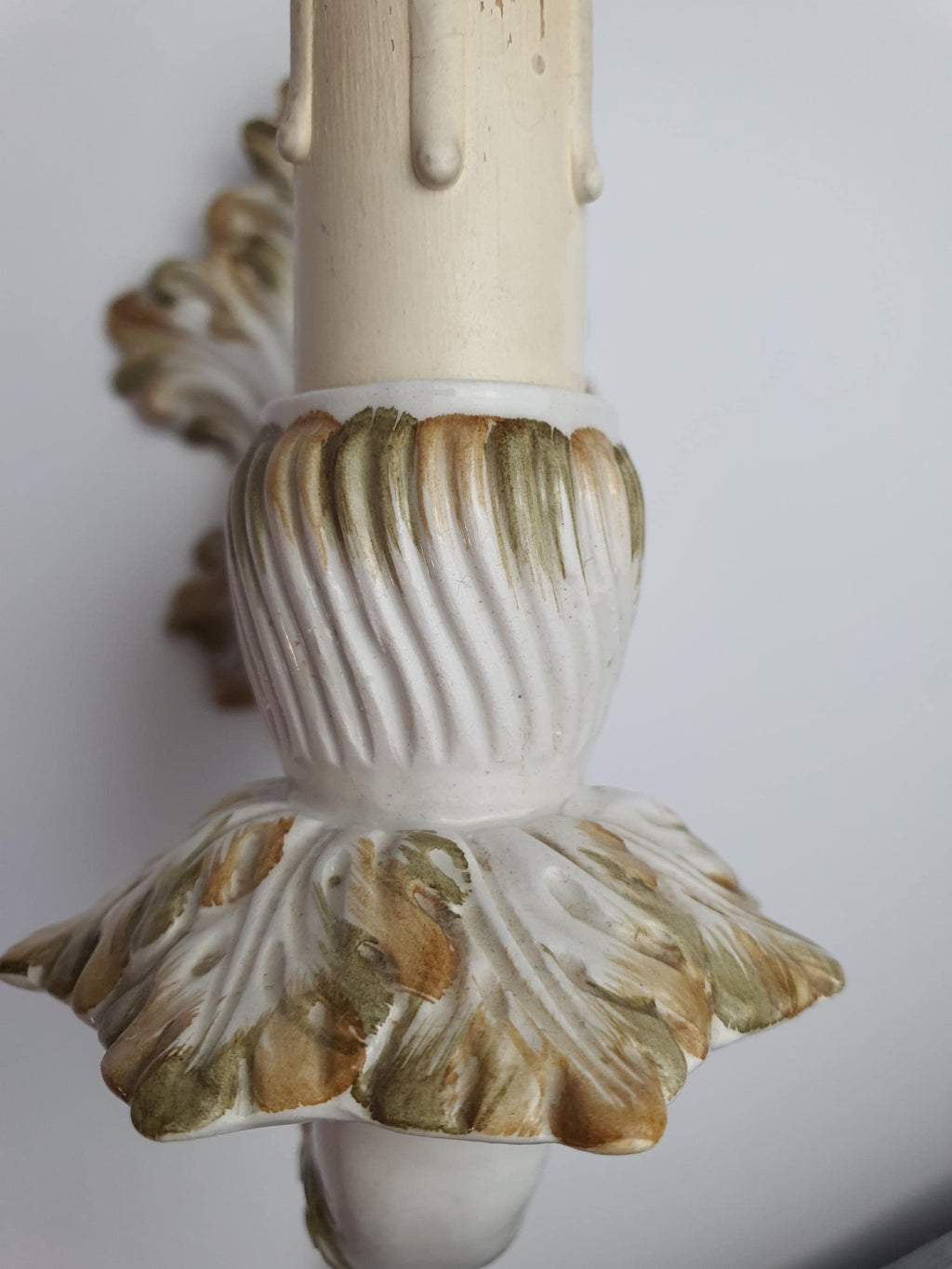 Brown and green decorative accents on the second ceramic wall sconce
