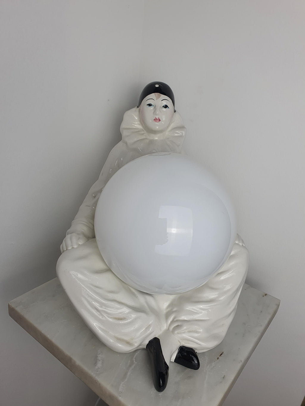 Vintage Italian Pierrot clown ceramic lamp in bedroom, warm white globe glow, theatrical commedia dell'arte accent light