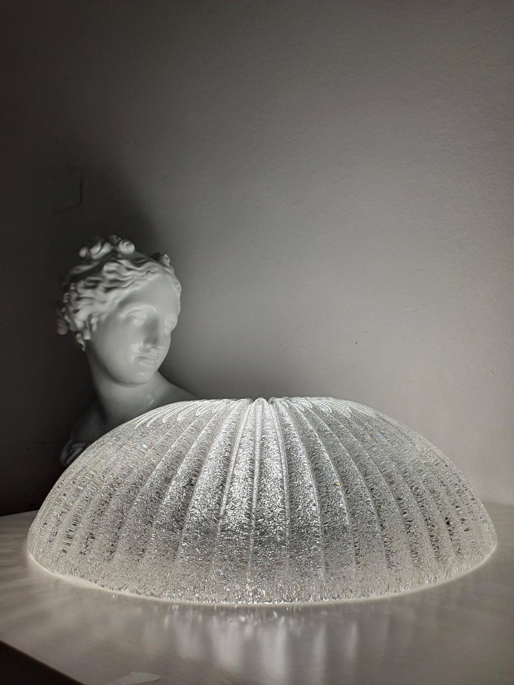 Venetian glass shell flush mount front view, ribbed relief pattern, smooth transparent surface, low ceiling fixture