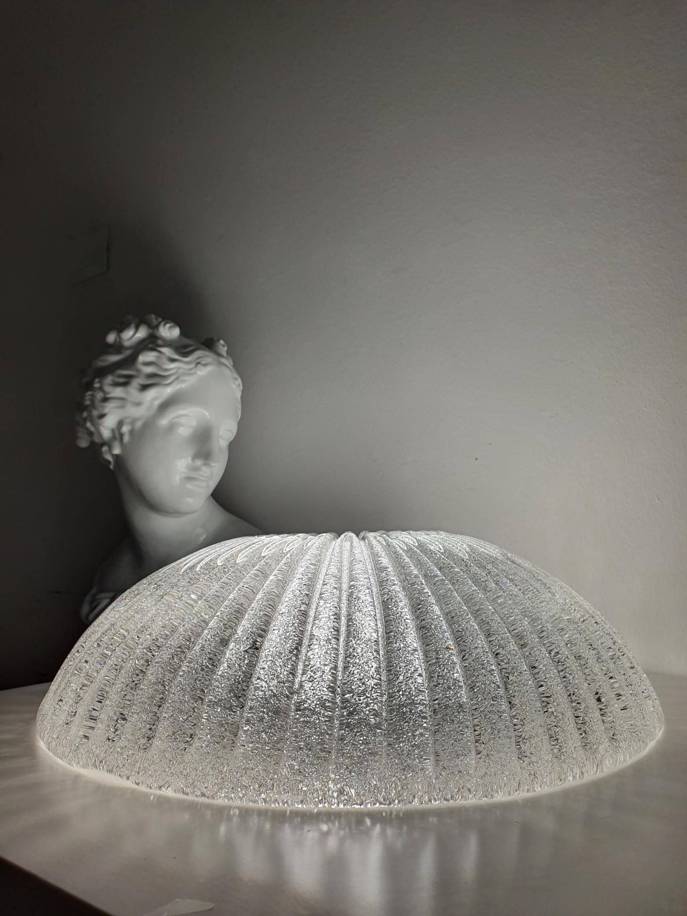 Venetian glass shell flush mount front view, ribbed relief pattern, smooth transparent surface, low ceiling fixture