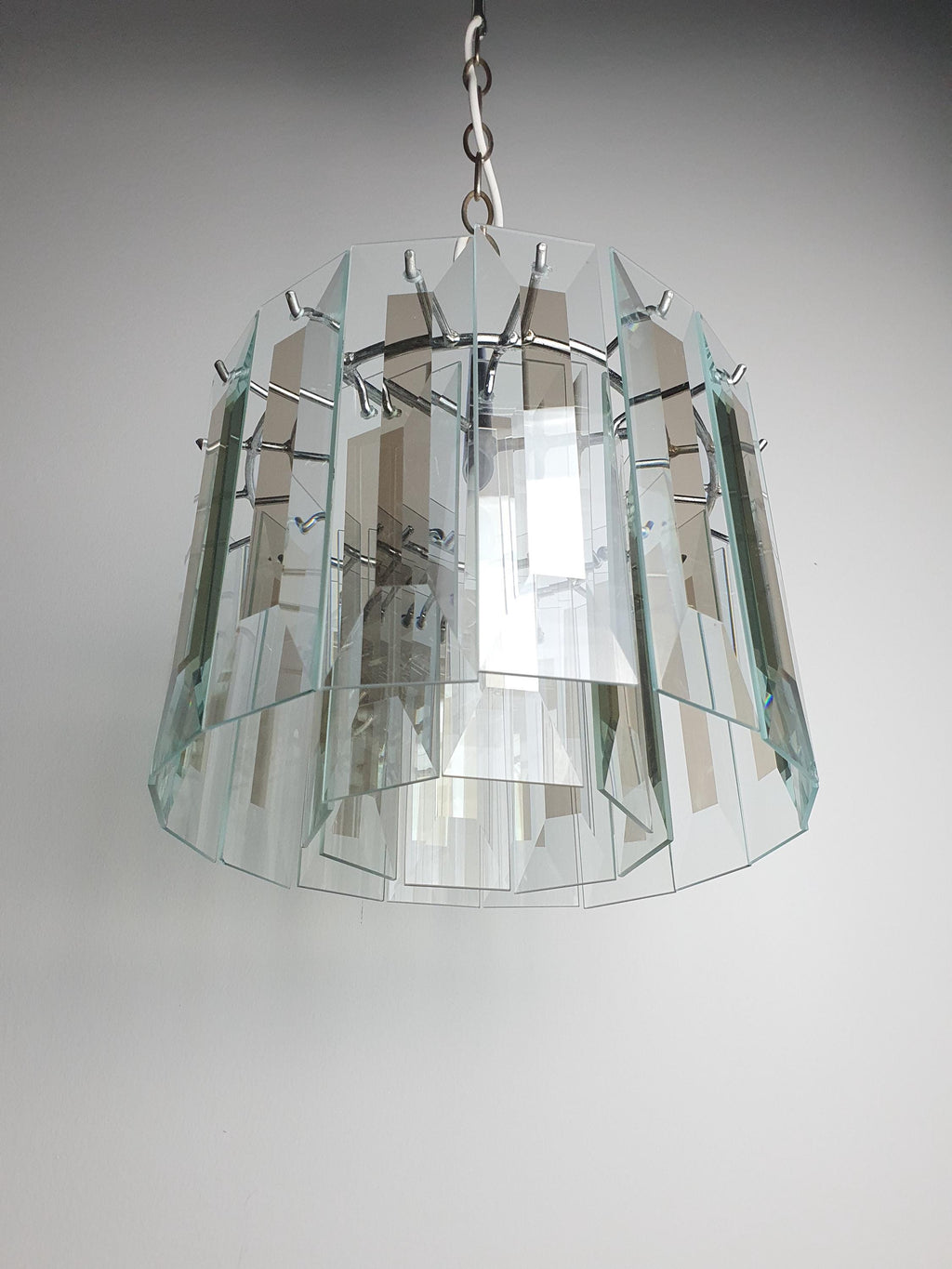 Close-up of rectangular crystal glass pendants on vintage Art Deco chandelier, geometric petal cascade, excellent clarity