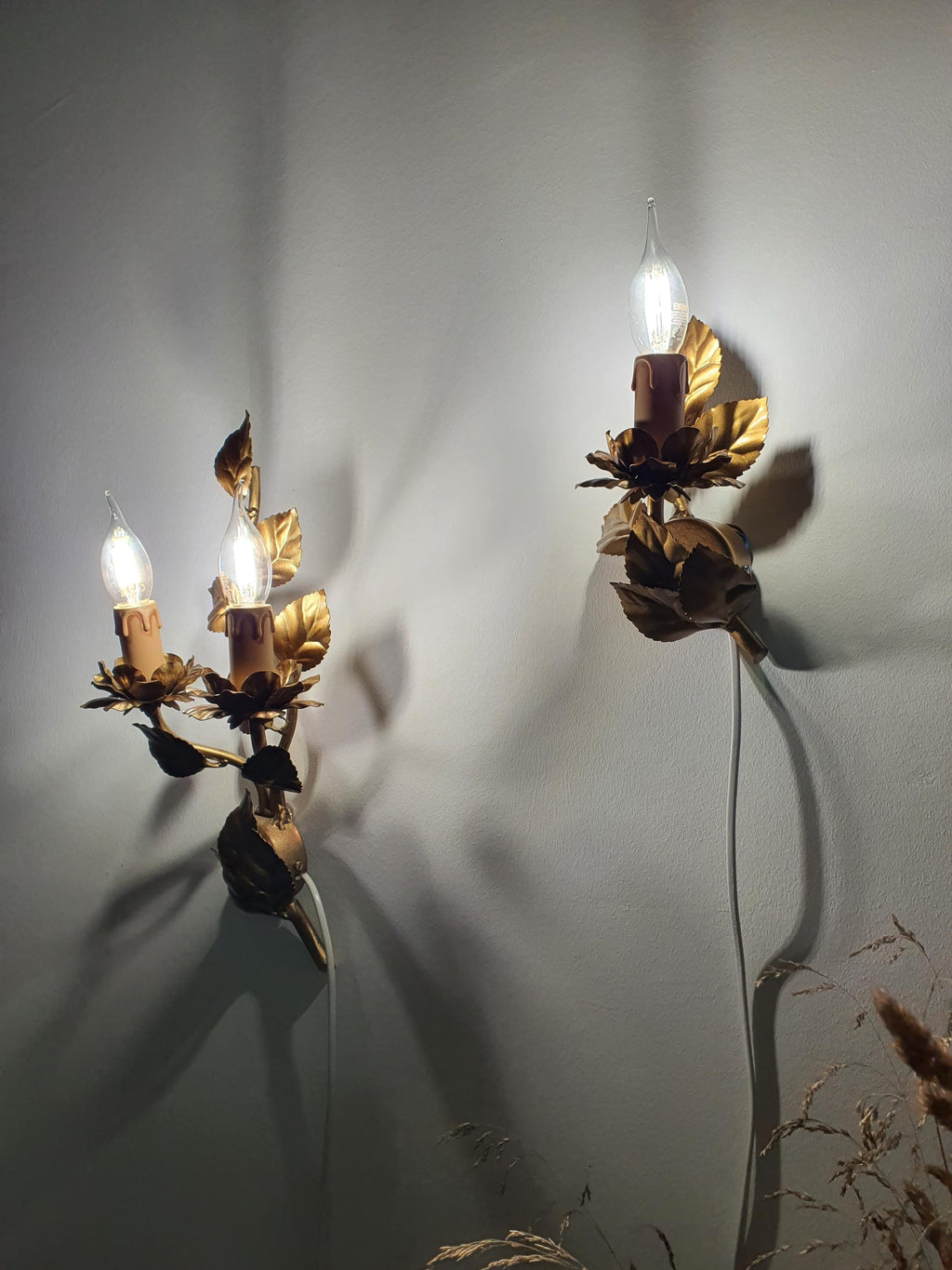 Age-related patina and surface wear on a vintage metal wall light

