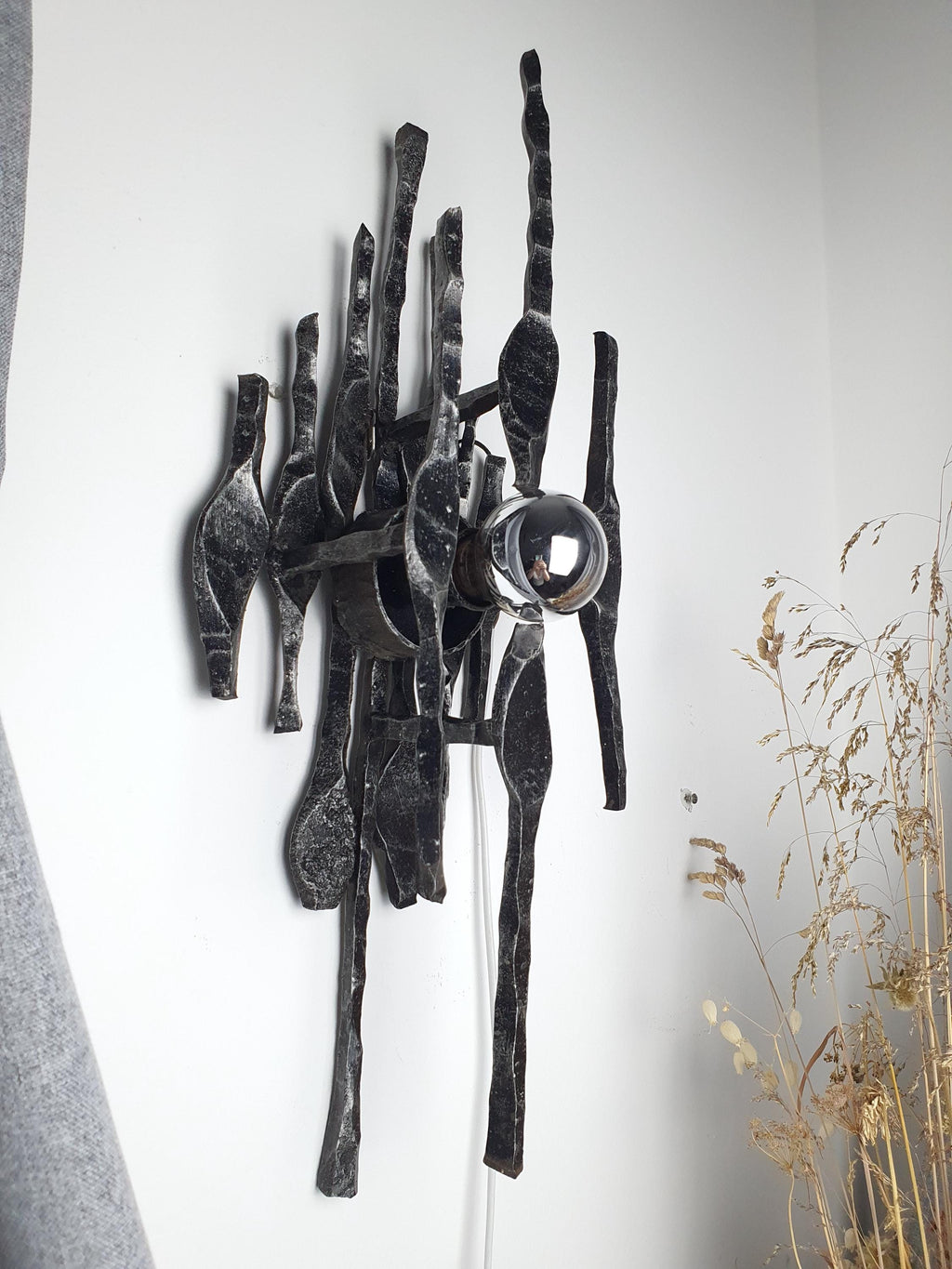 1970s wrought iron wall sconce side profile, textured metal surface and chrome detail