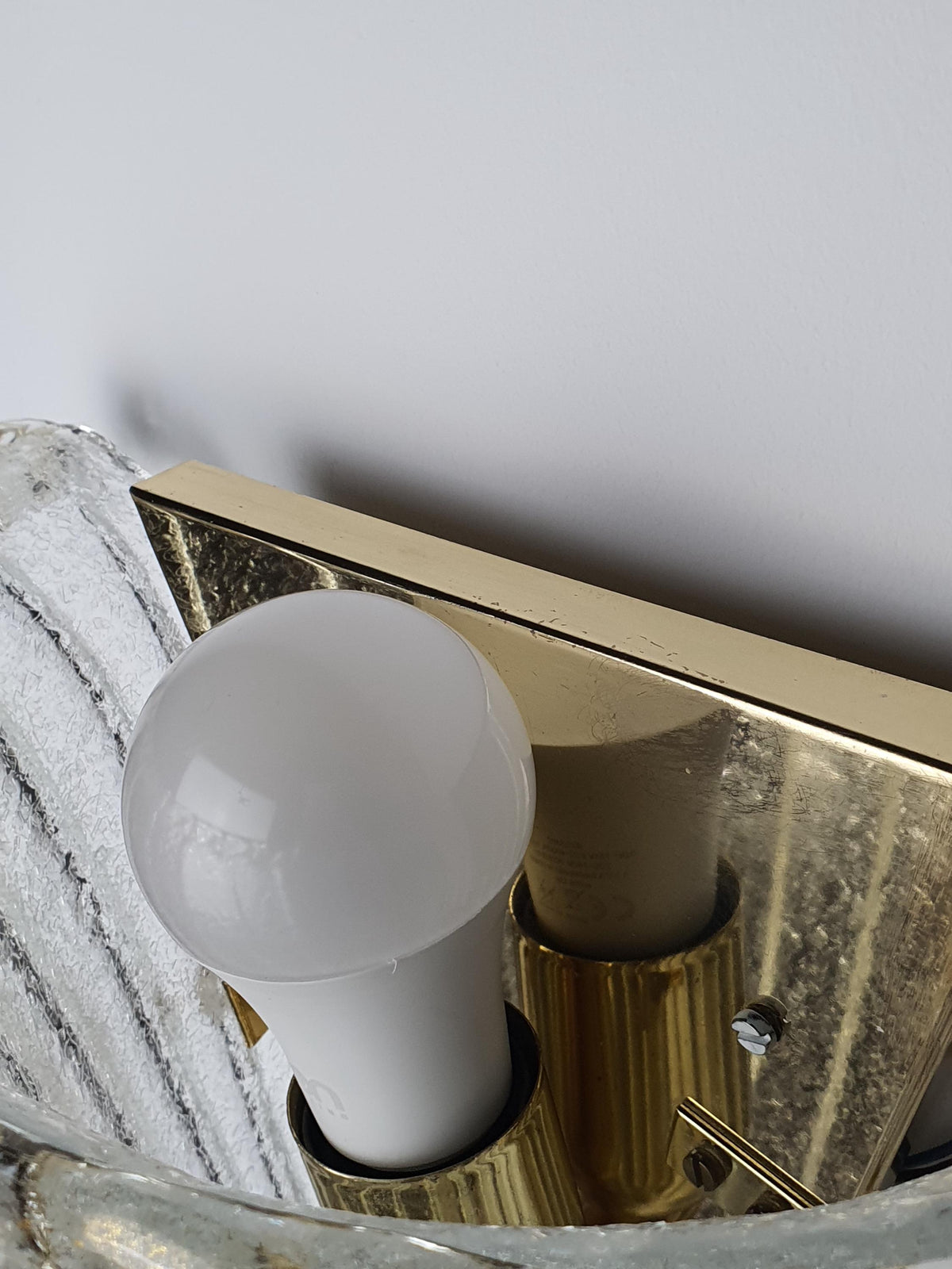 Different metal bases on a pair of vintage Venetian glass sconces
