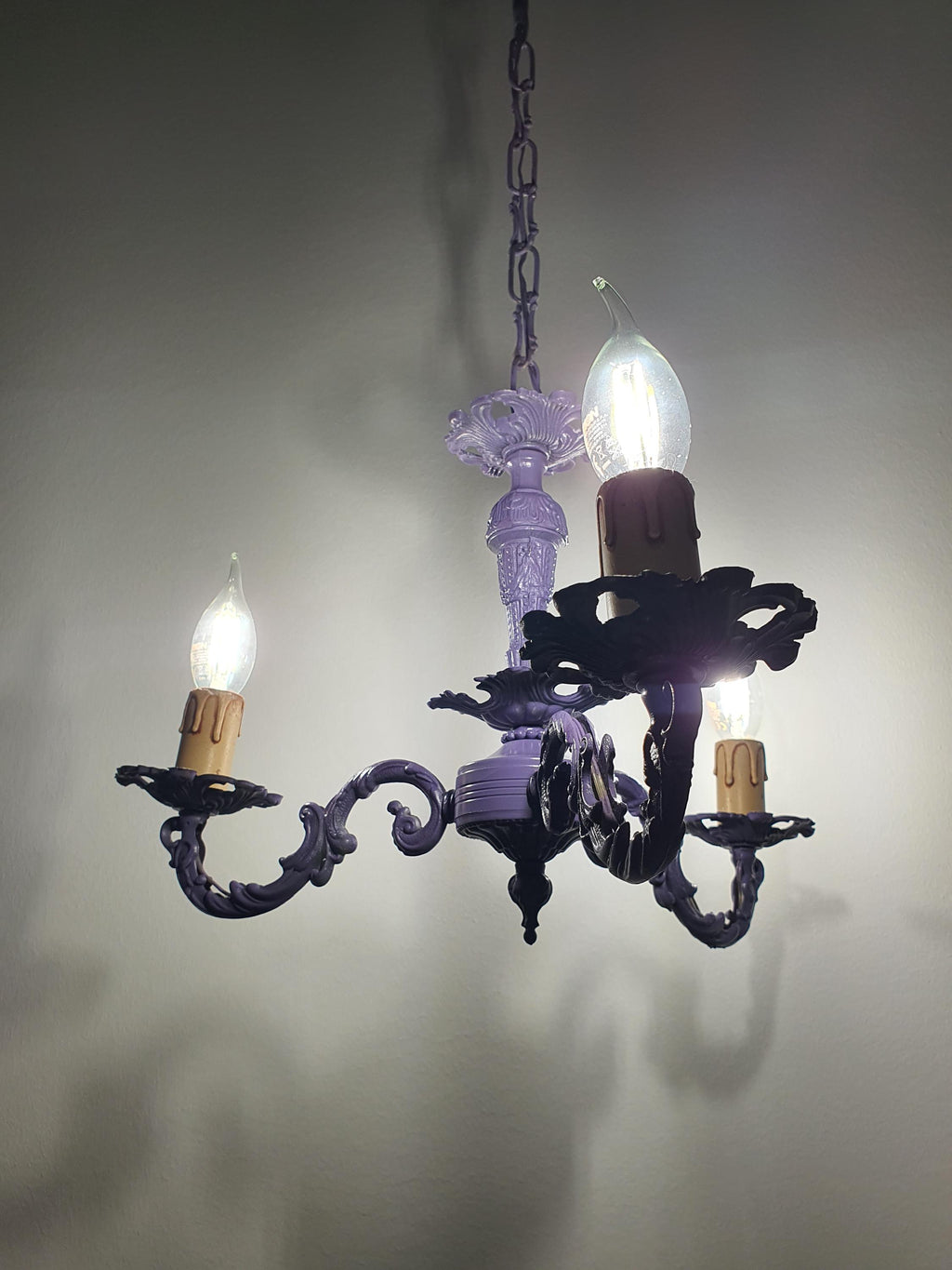 Purple candle-style chandelier with gracefully curved arms
