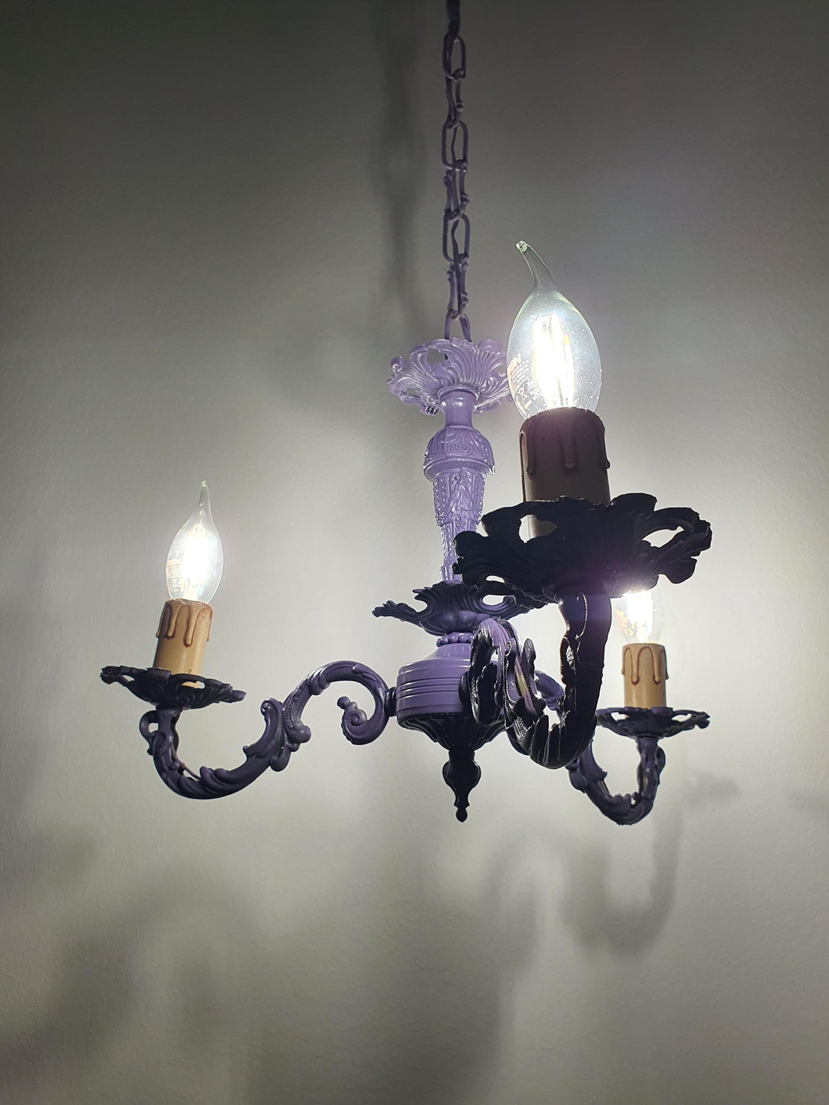 Purple candle-style chandelier with gracefully curved arms

