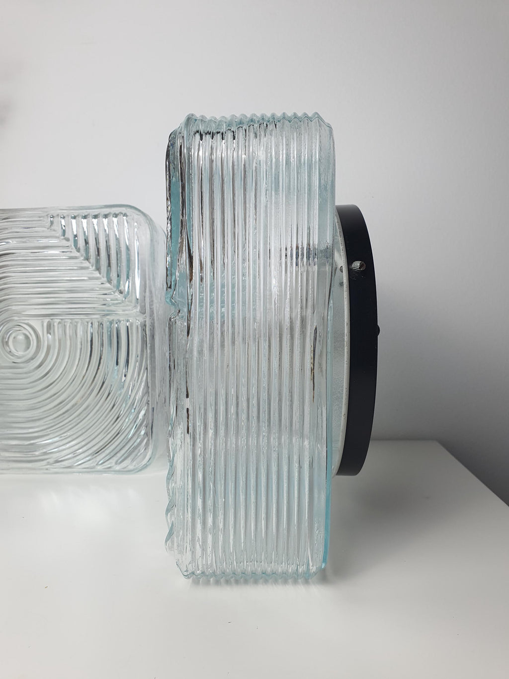 Vintage square Brutalist MCM wall sconce side profile, showing 10cm shallow depth, stamped clear glass and metal base