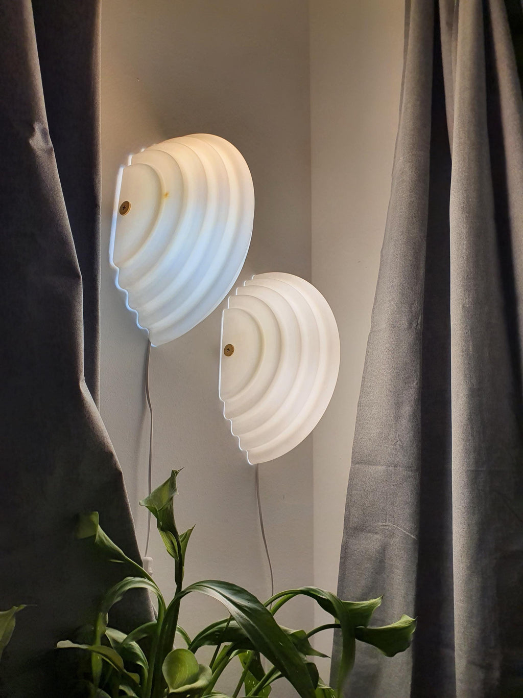 Vintage Sirrah Kumo 2 sconce — illuminated, even warm glow through beige acrylic