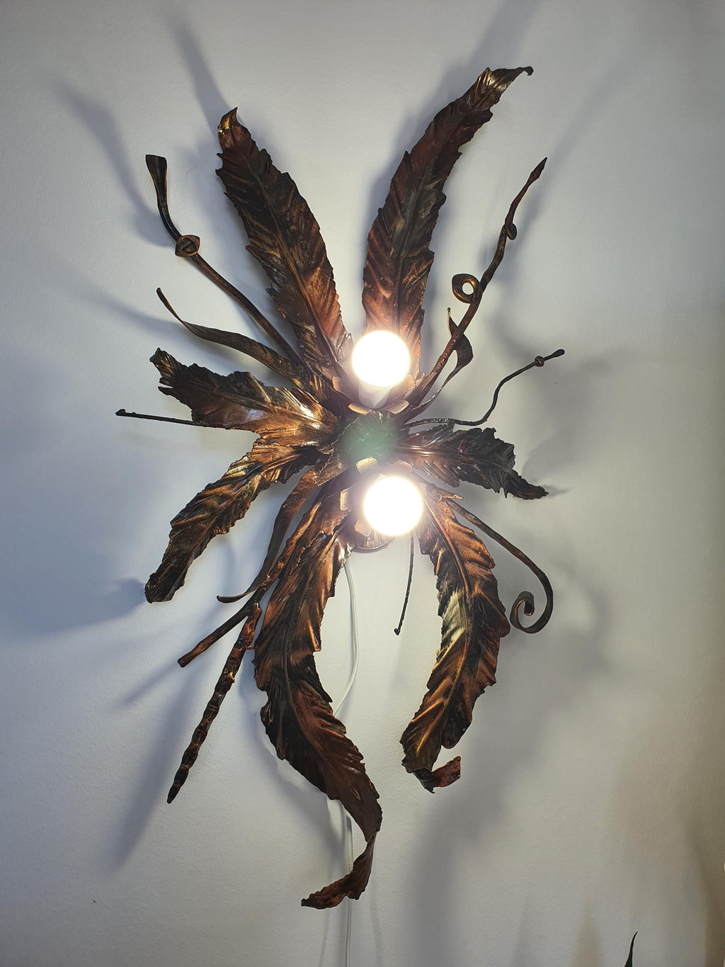 Large gilded metal light combining Hollywood Regency and bohemian botanical styling
