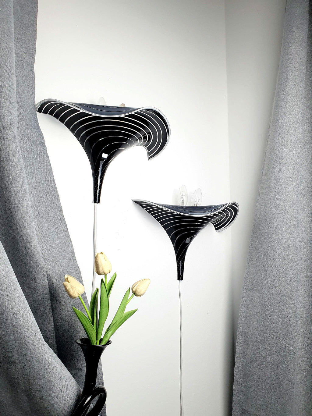 Pair of vintage Murano glass calla lily wall sconces, black and clear zebra stripe layered art glass, wave silhouette, Italy 1960s–1980s