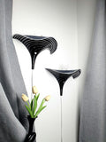 Pair of vintage Murano glass calla lily wall sconces, black and clear zebra stripe layered art glass, wave silhouette, Italy 1960s–1980s