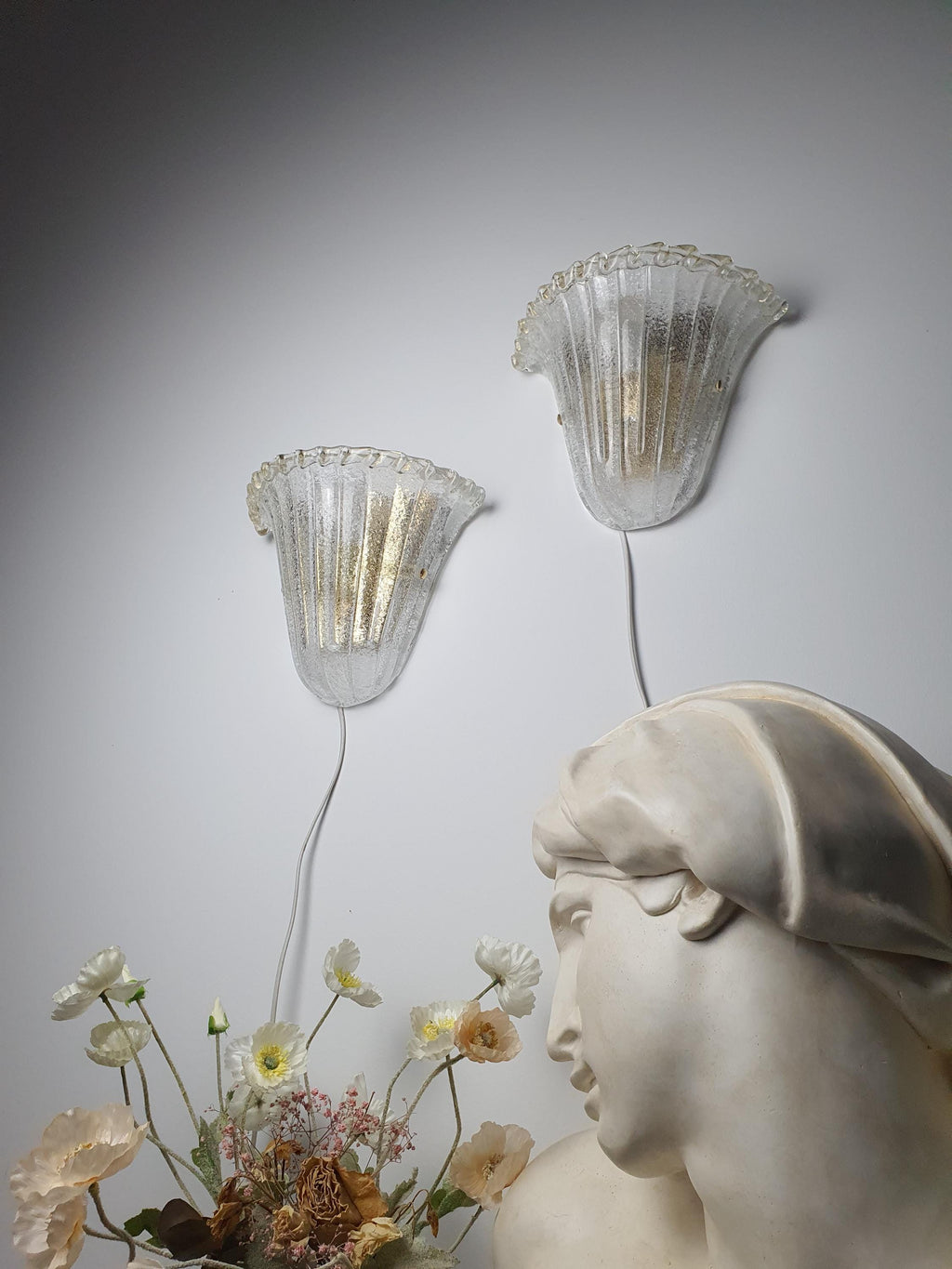 Age-related wear on the metal mount of a vintage Murano glass sconce
