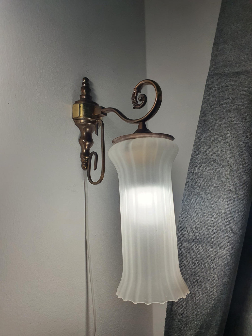 Vintage Italian satin frosted flute wall sconce facing downward, showing reversible hook mount installation, brass base