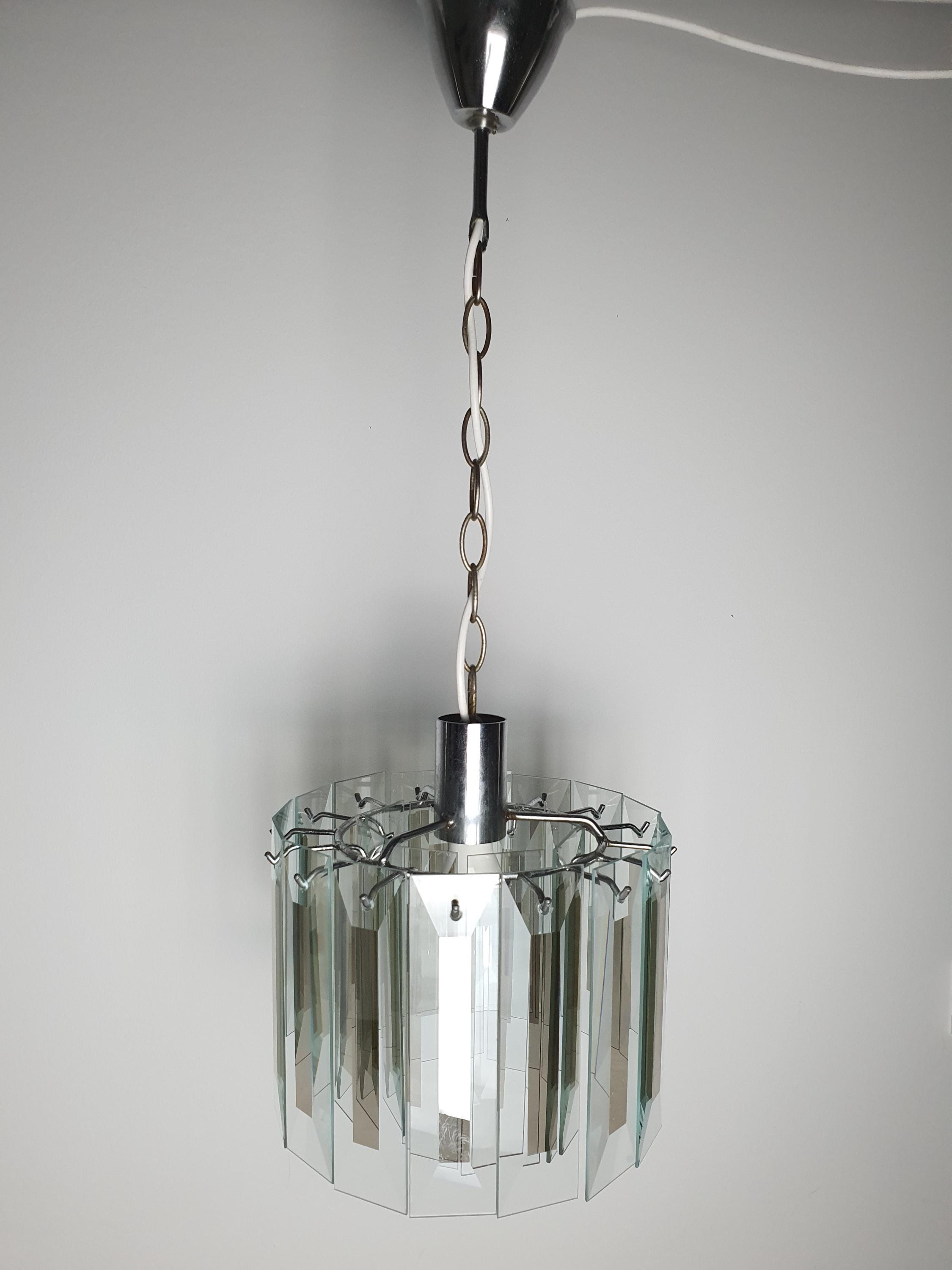 Vintage Art Deco chandelier front view, geometric rectangular crystal glass pendants cascading petal arrangement, aged chrome