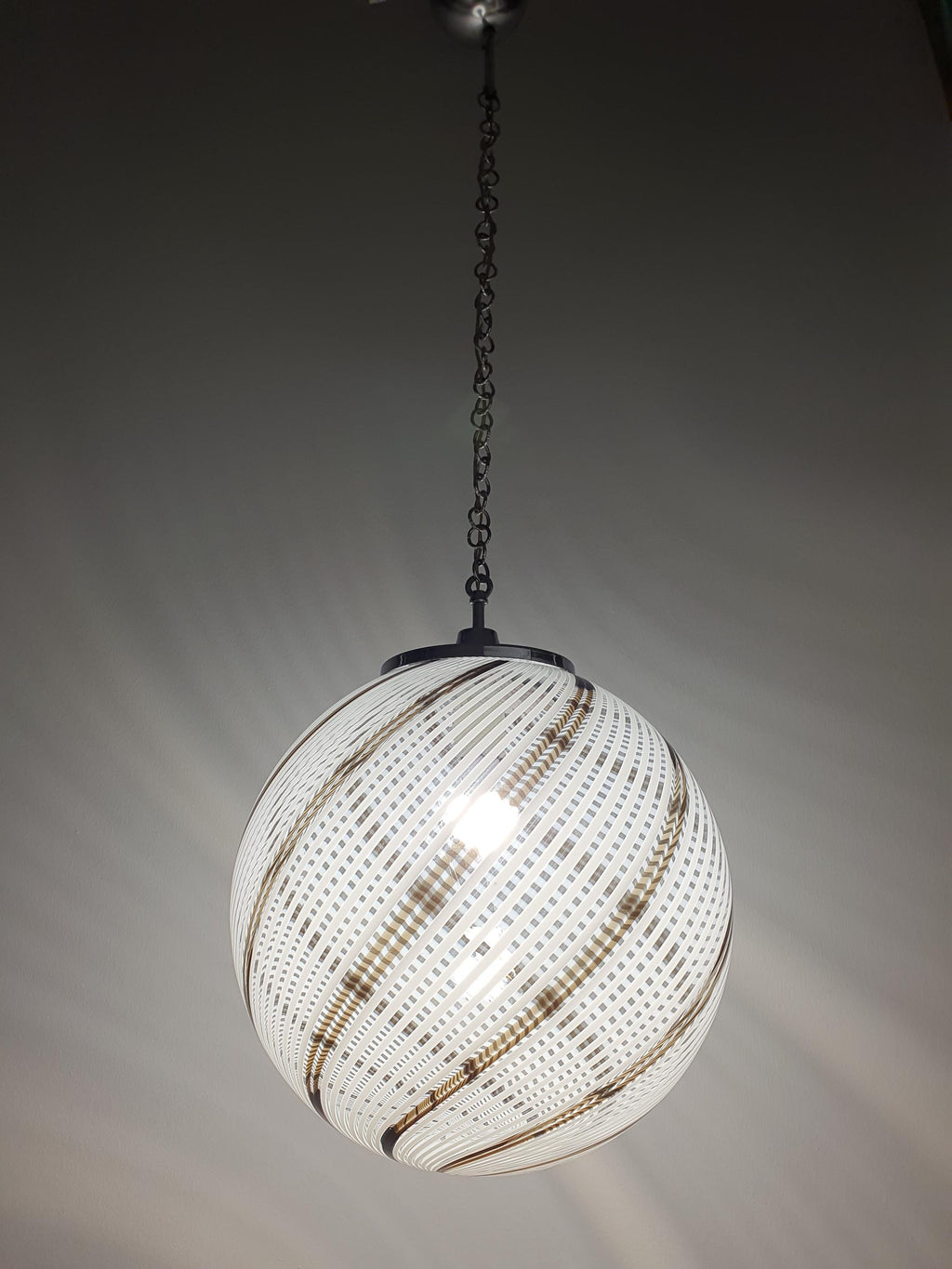 Venini-style Murano glass globe pendant front view, white and brown filigree lines in clear glass
