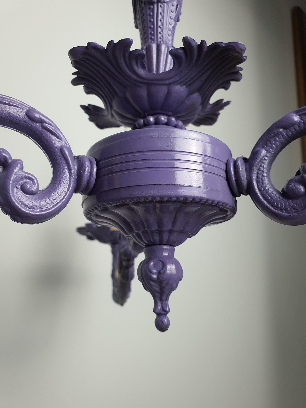 Age-related wear and imperfections on the chandelier’s painted finish
