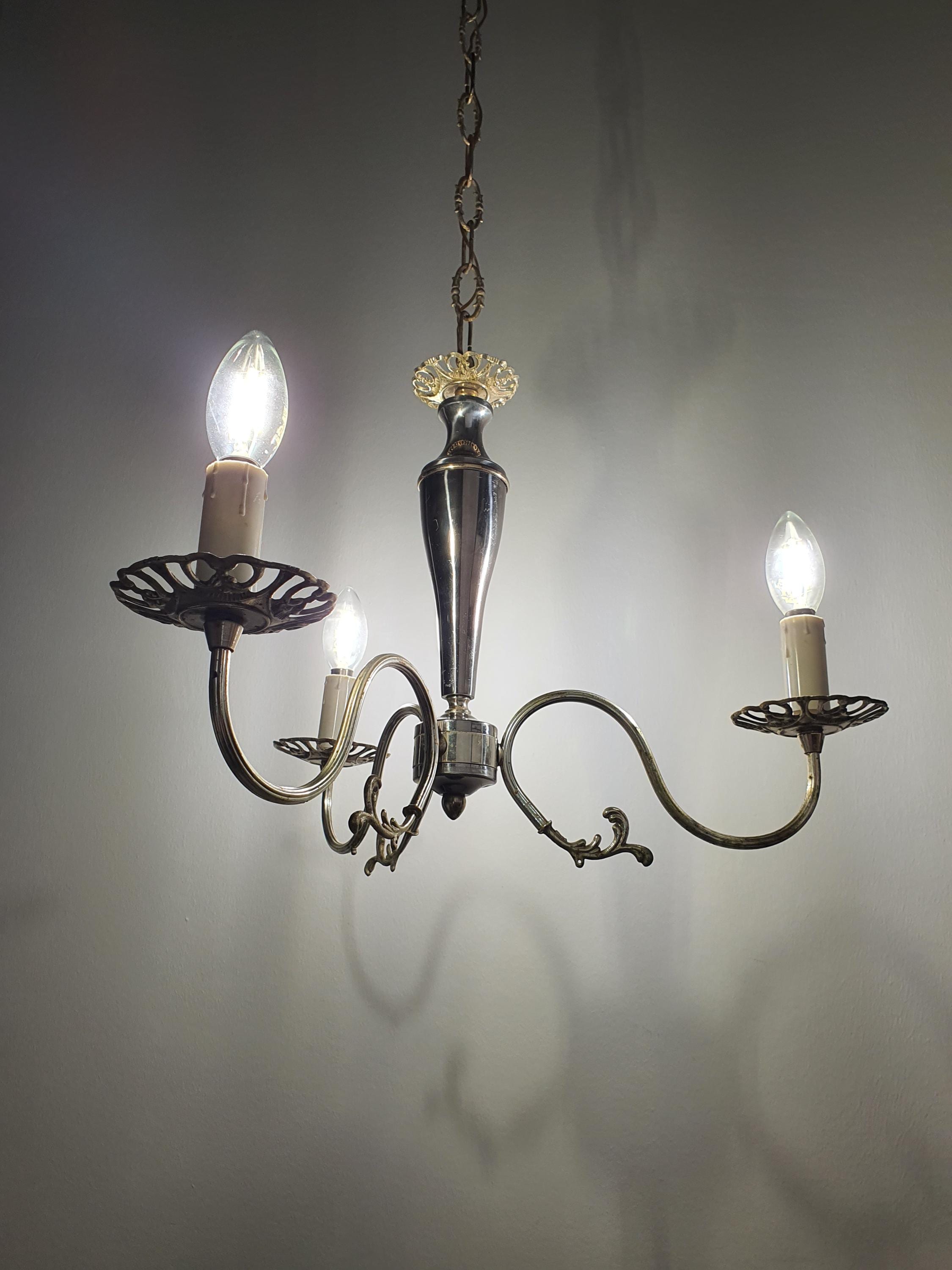 Vintage 1950s Italian candle chandelier installed above dining table, compact Victorian style, warm glow