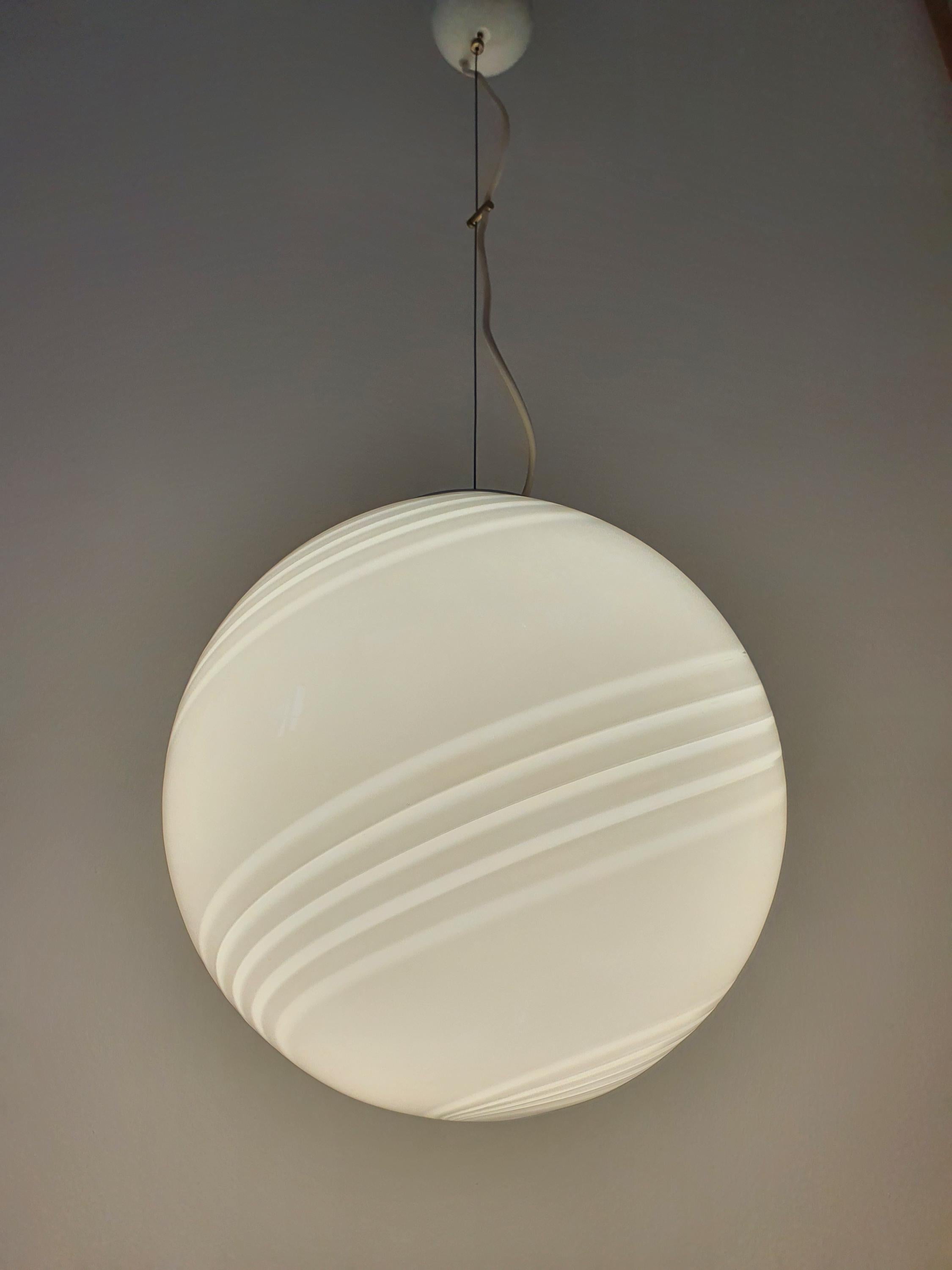 Vintage Murano large white swirl globe pendant in living room, statement MCM minimalist Italian lighting, soft white glow