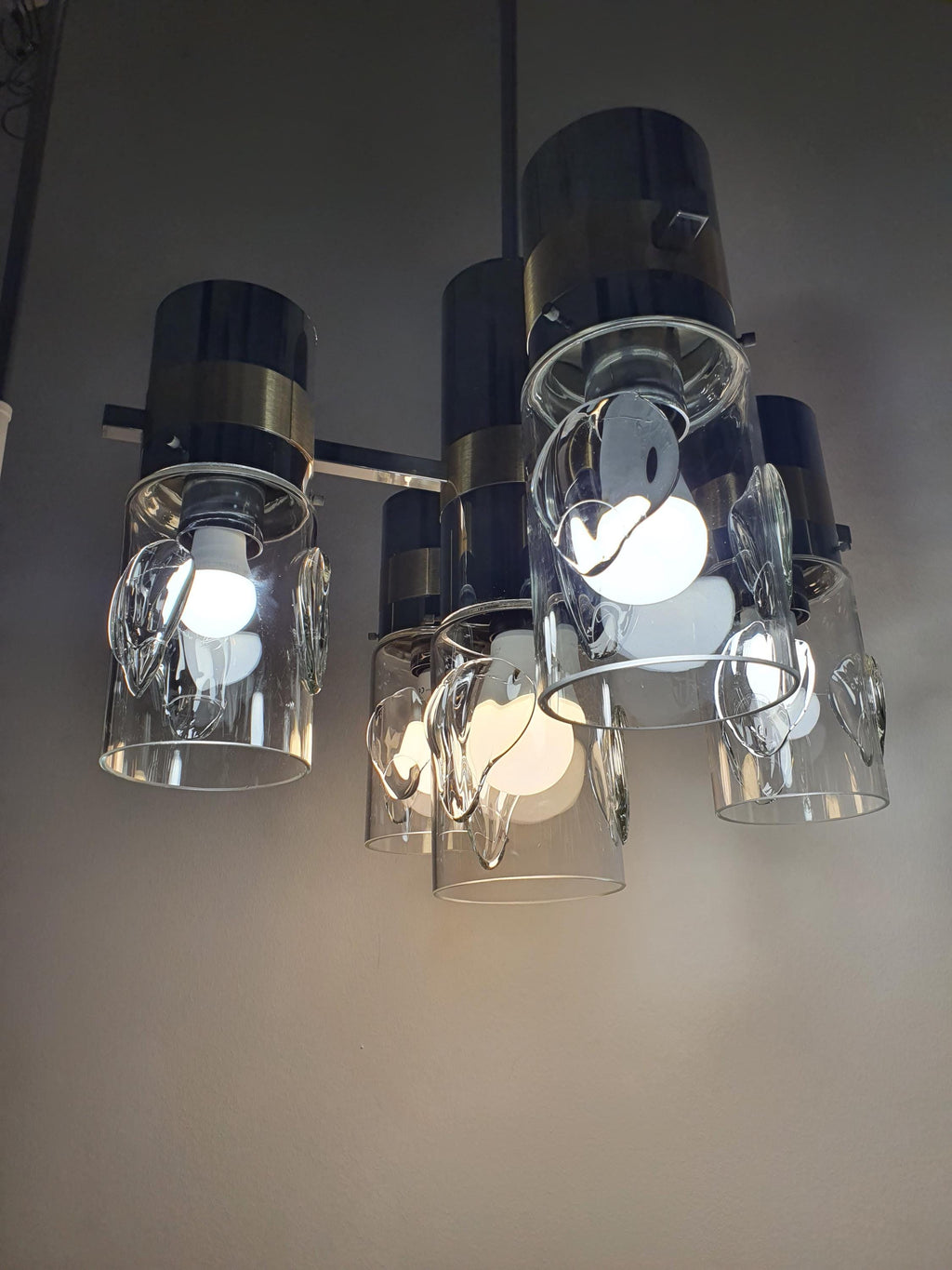 Close-up of handcrafted glass diffuser on vintage Space Age Sputnik chandelier, soft light diffusion, chrome gold arm detail