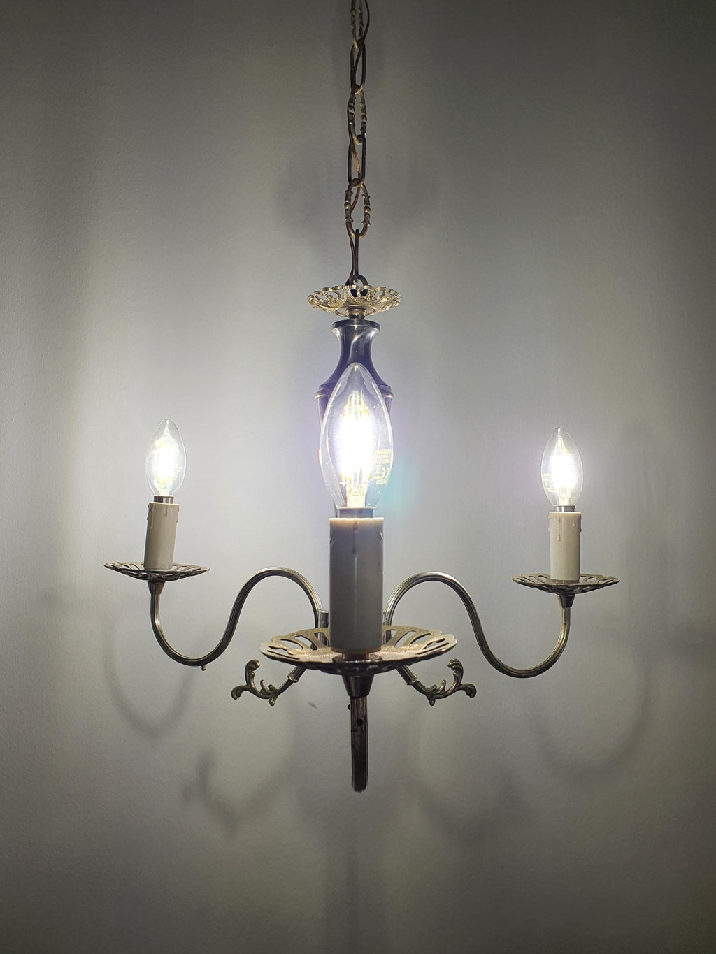 Vintage Italian 3-arm chandelier lit, warm candlelight glow, silver patina, compact Victorian design