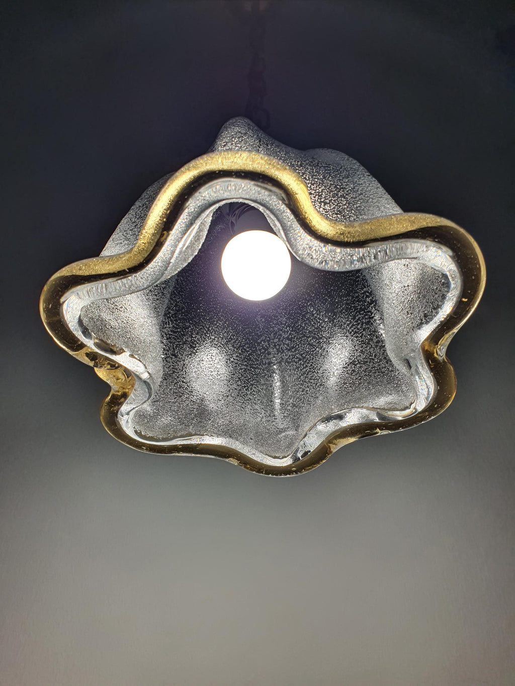 Vintage Murano bell tulip pendant unlit, showing graniglia icy interior, smooth glossy exterior and yellow rim silhouette