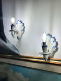 Pair of vintage Italian Bassano ceramic wall sconces, white glaze with hand-painted blue decorative details, age crazing, 1970s–1980s