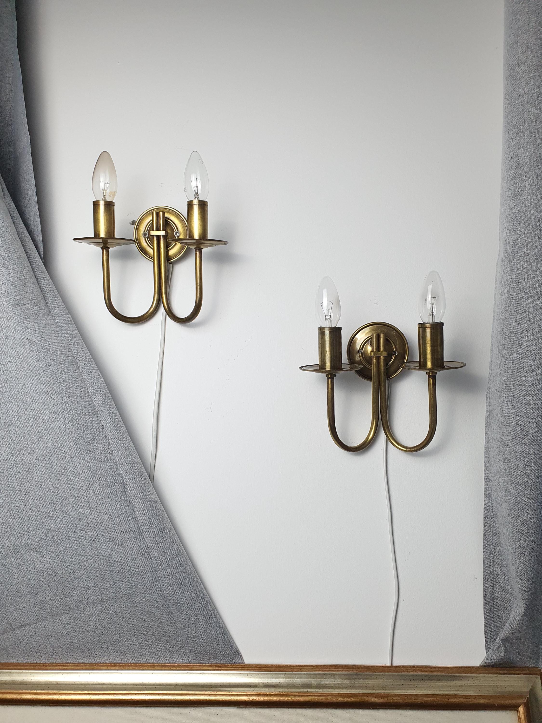 Pair of vintage Italian double-arm lacquered brass wall sconces lit, warm brass glow, two E14 arms, Hollywood Regency interior