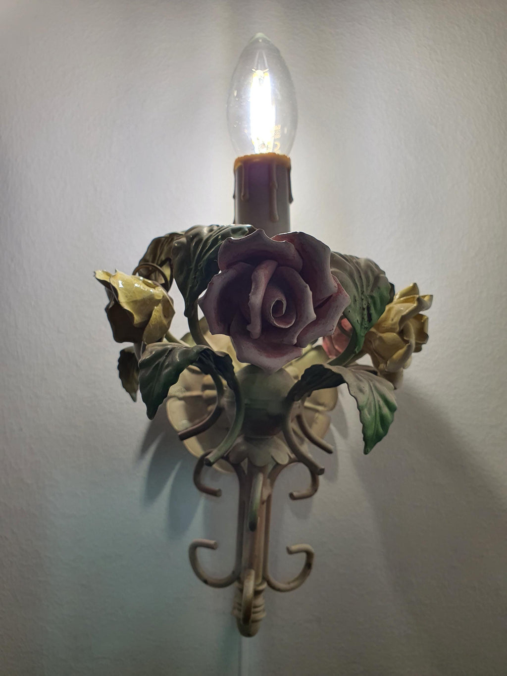 Vintage tole wall sconce — floral porcelain and green metal arm detail