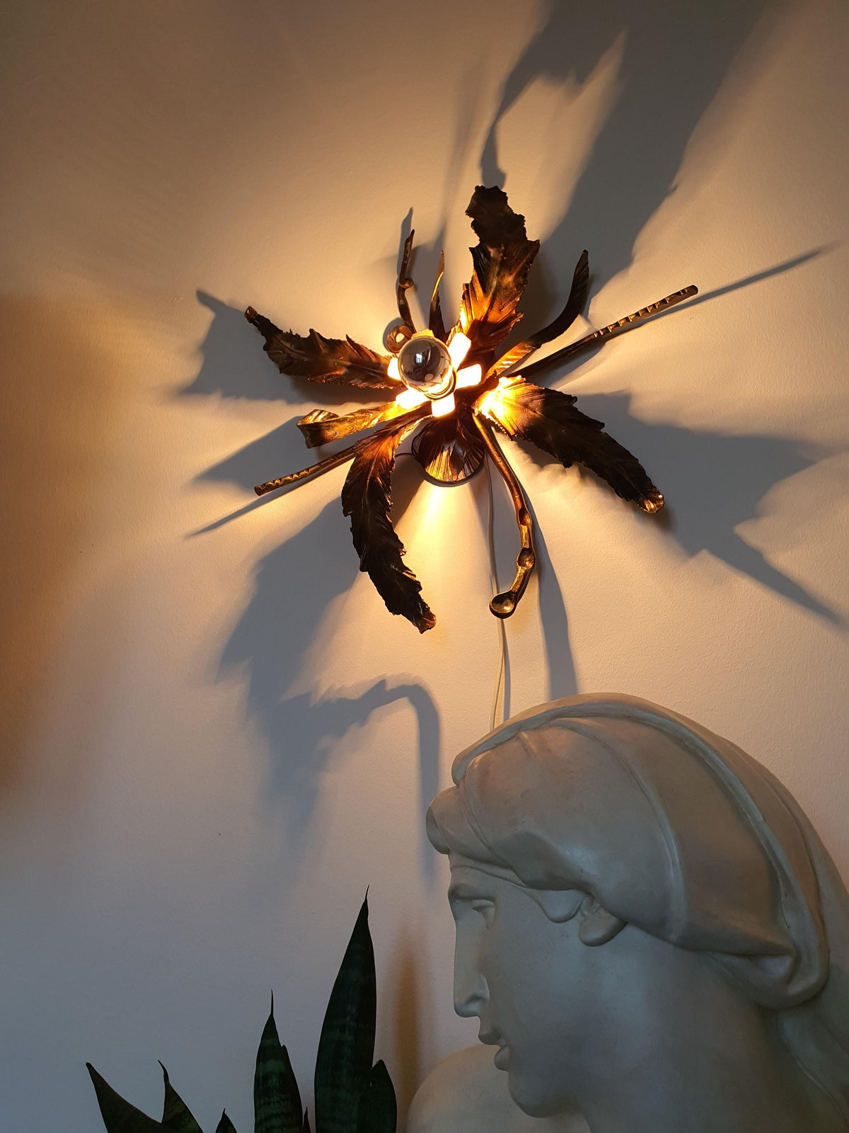 Painted-finish imperfections on a vintage handcrafted botanical light
