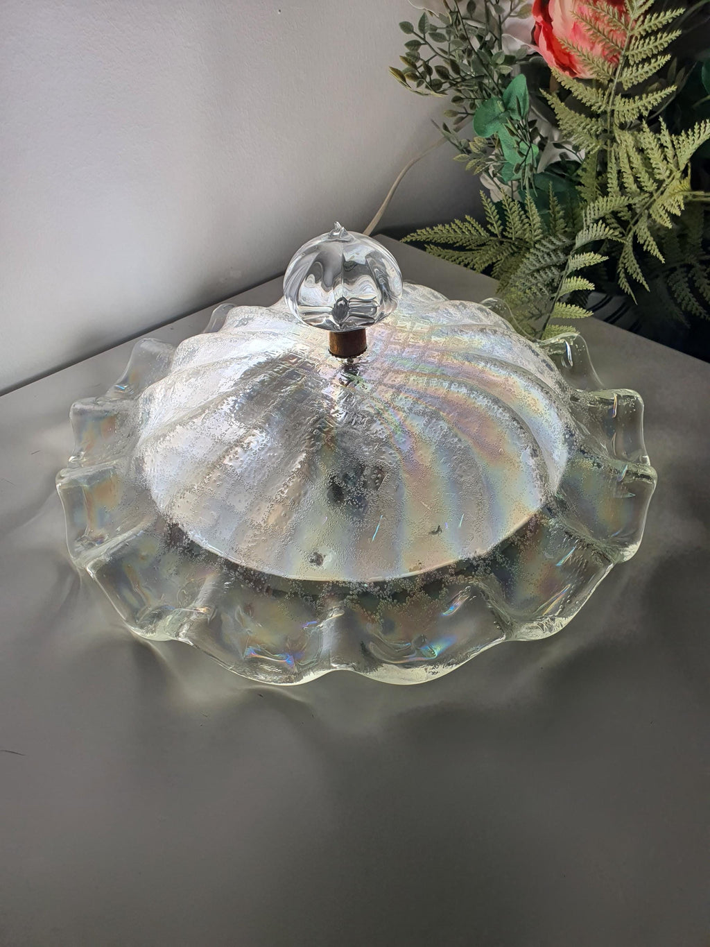 Detail of the glass-sand texture on a vintage ceiling light shade
