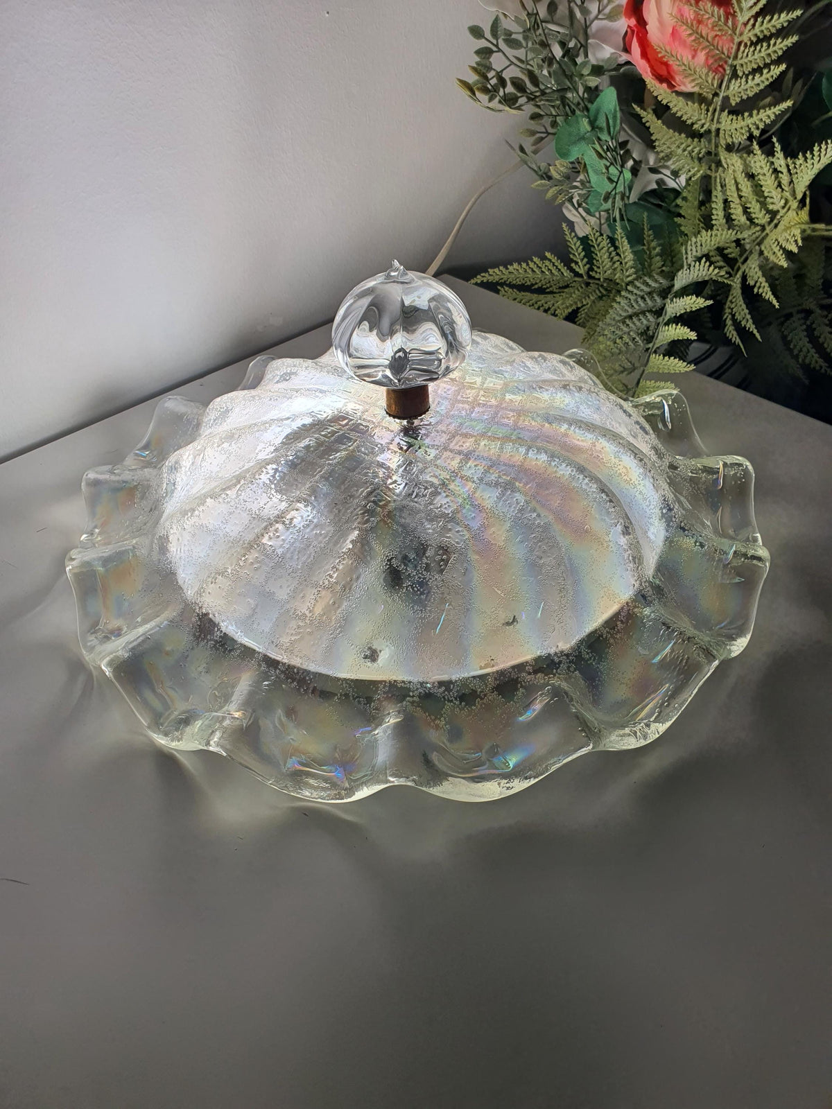 Detail of the glass-sand texture on a vintage ceiling light shade
