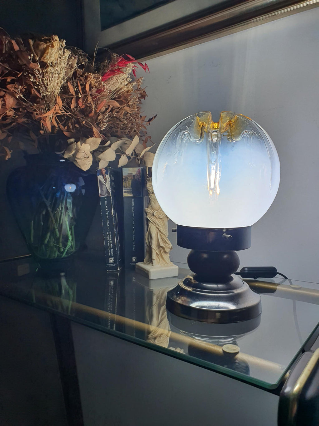 Mazzega Murano table lamp front view, white-to-clear gradient globe, amber crown, inverse caramel drip relief, wood and chrome base