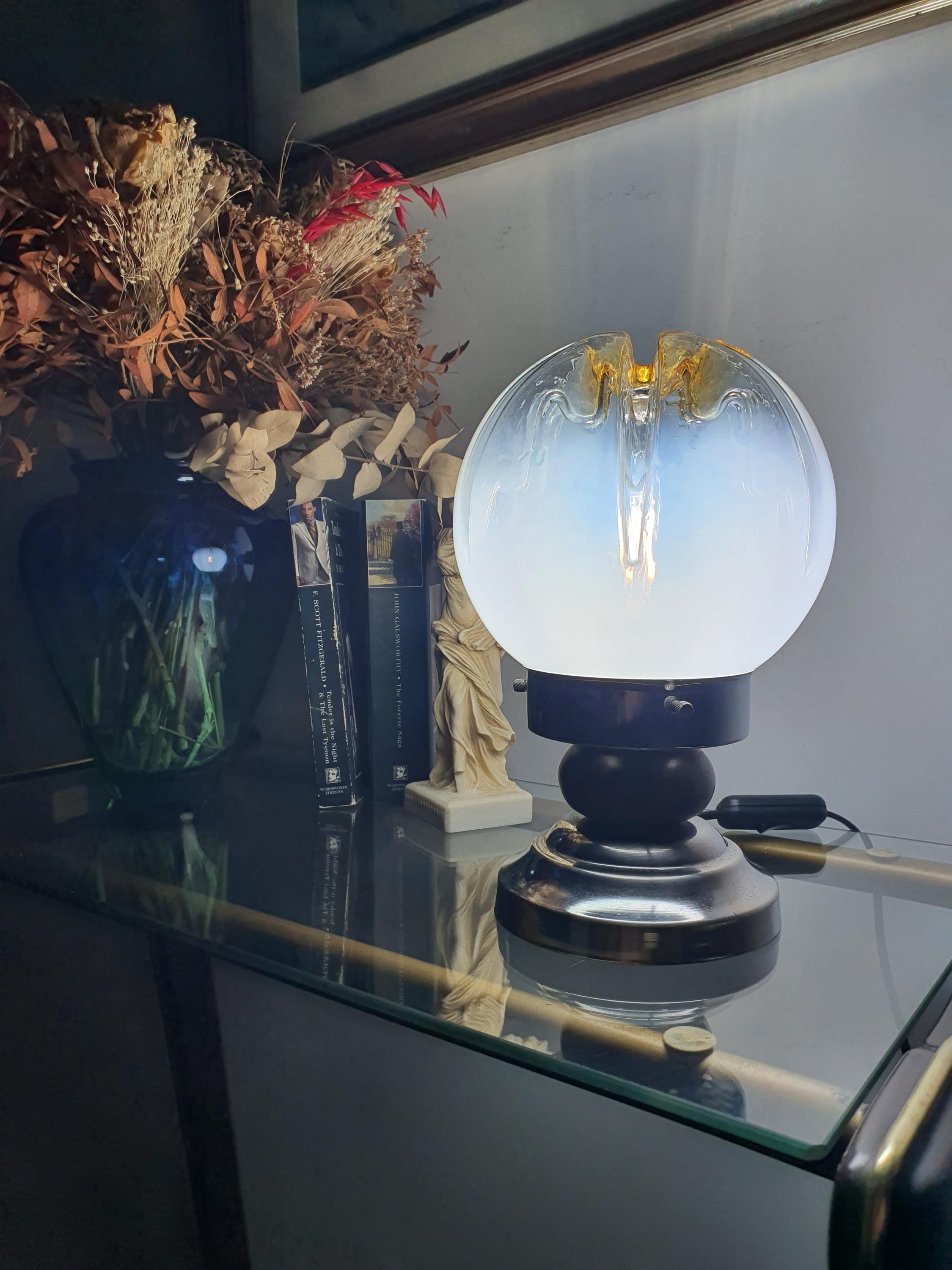 Mazzega Murano table lamp front view, white-to-clear gradient globe, amber crown, inverse caramel drip relief, wood and chrome base