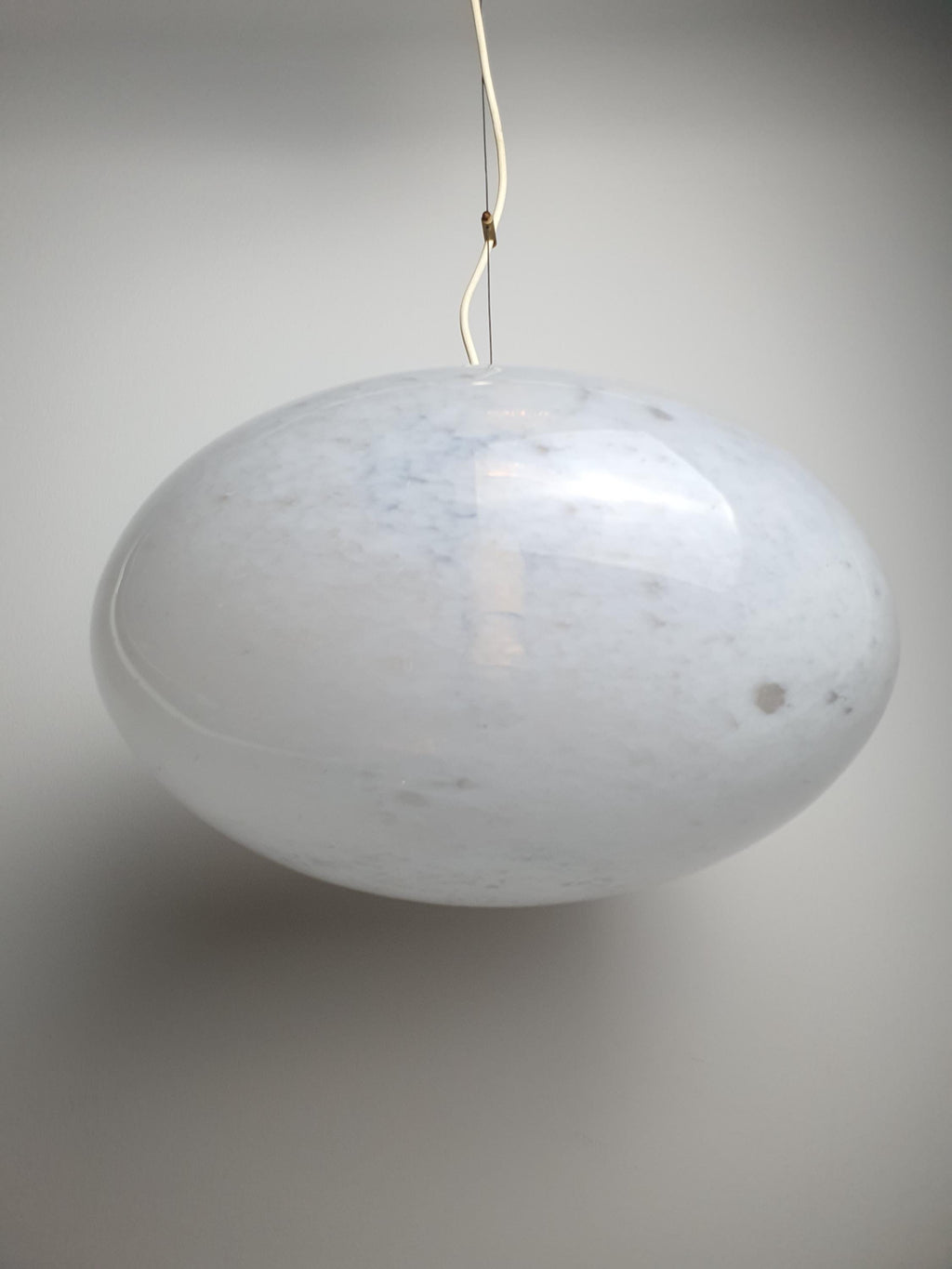 Vue de dessous de la suspension globe en verre de Murano blanc à bulles, douille E27 visible