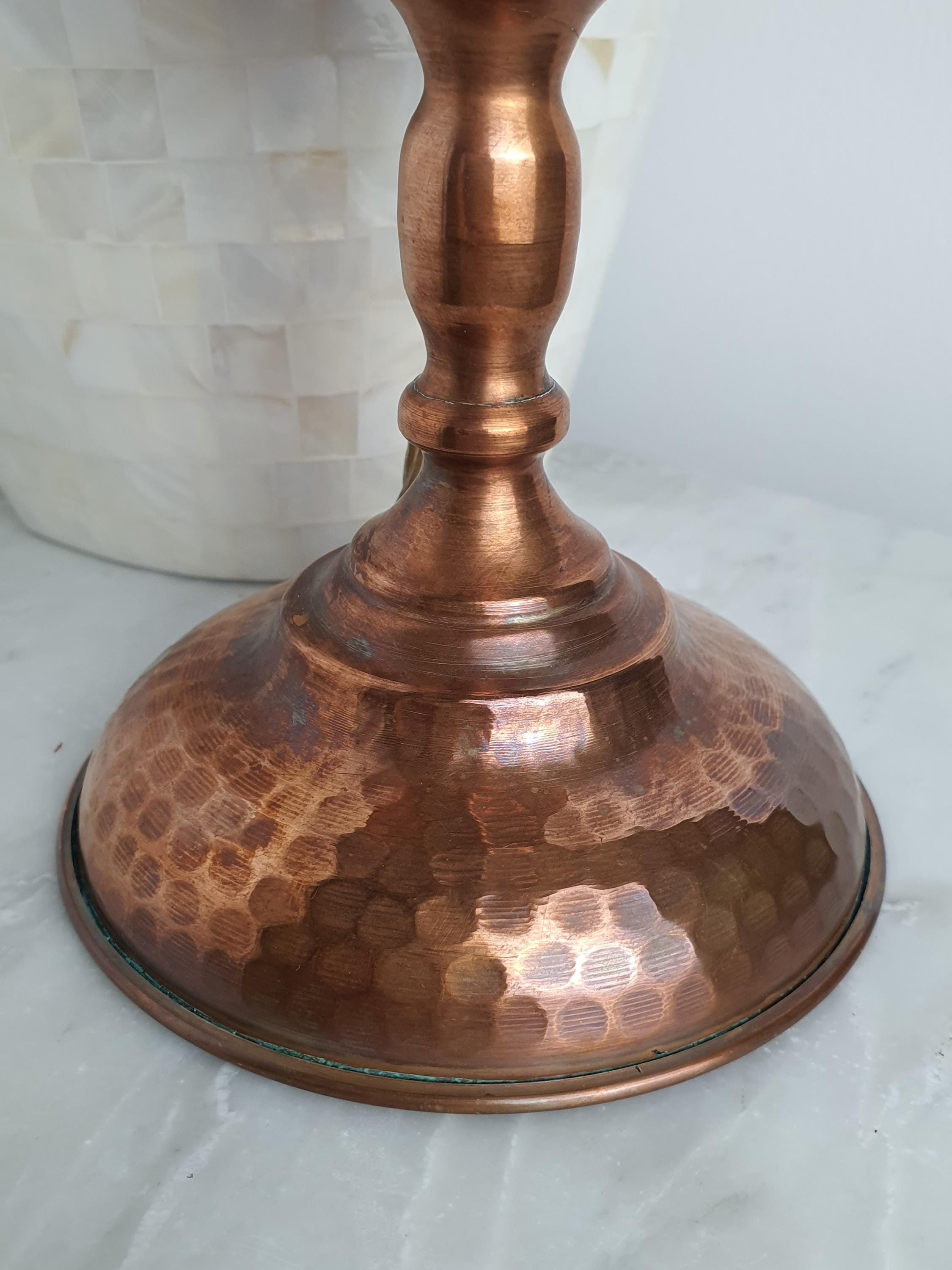 Close-up of aged copper patina and oxidation on vintage 1950s Italian oil lamp body, authentic vintage character