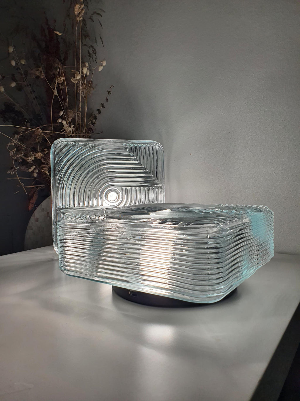 Pair of vintage square Brutalist MCM wall sconces lit, architectural stamped clear glass light diffusion, mixed metal bases