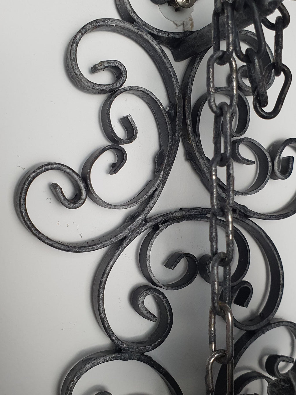Handcrafted wrought iron wall light — dark grey textured surface and forged iron detail