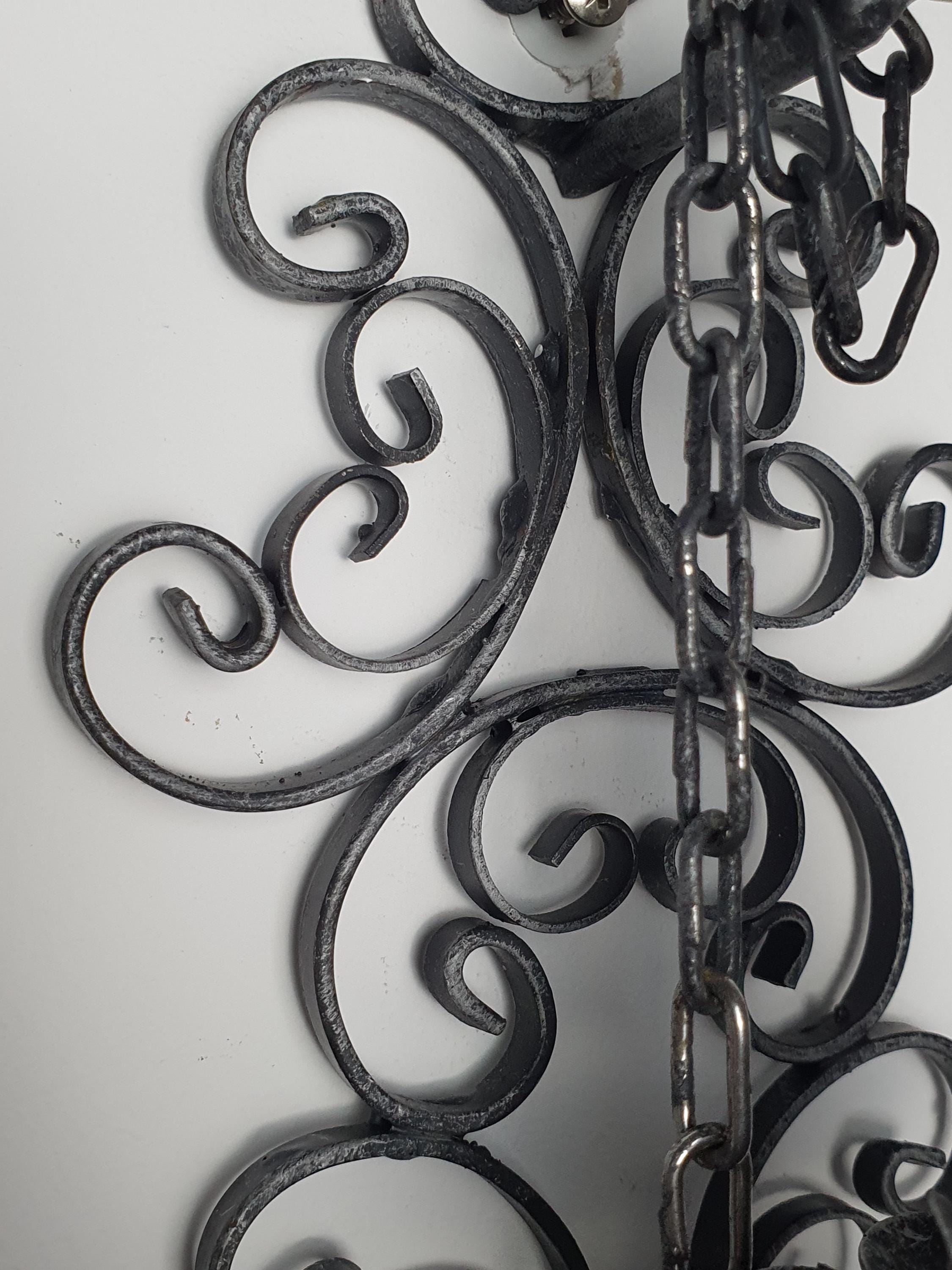 Handcrafted wrought iron wall light — dark grey textured surface and forged iron detail