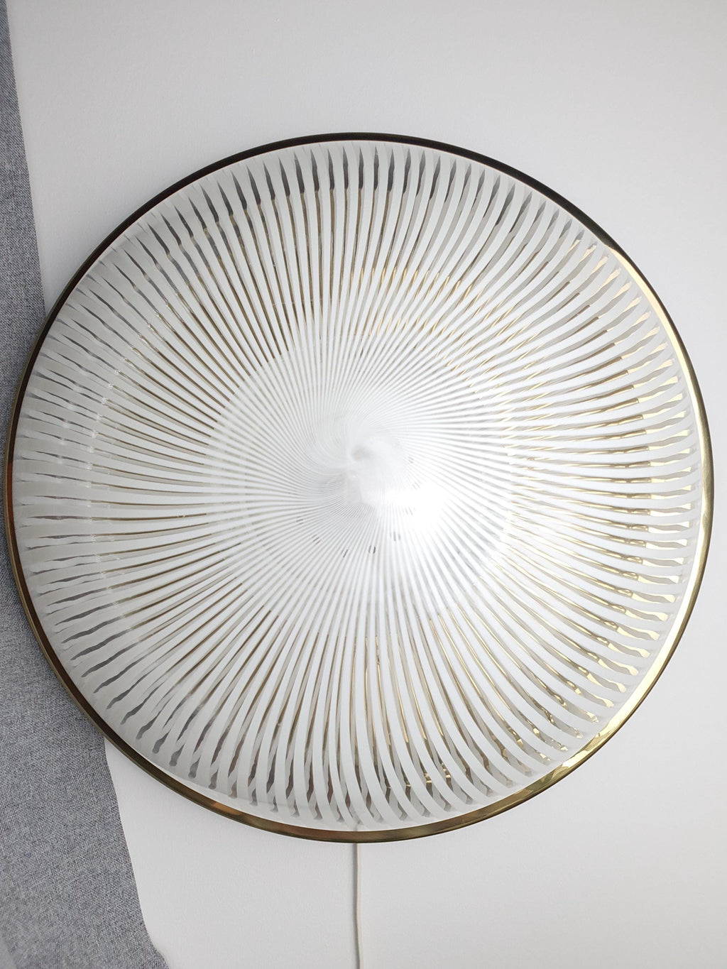 Close-up of Venini filigrana white filigree lines suspended in clear Murano glass shade