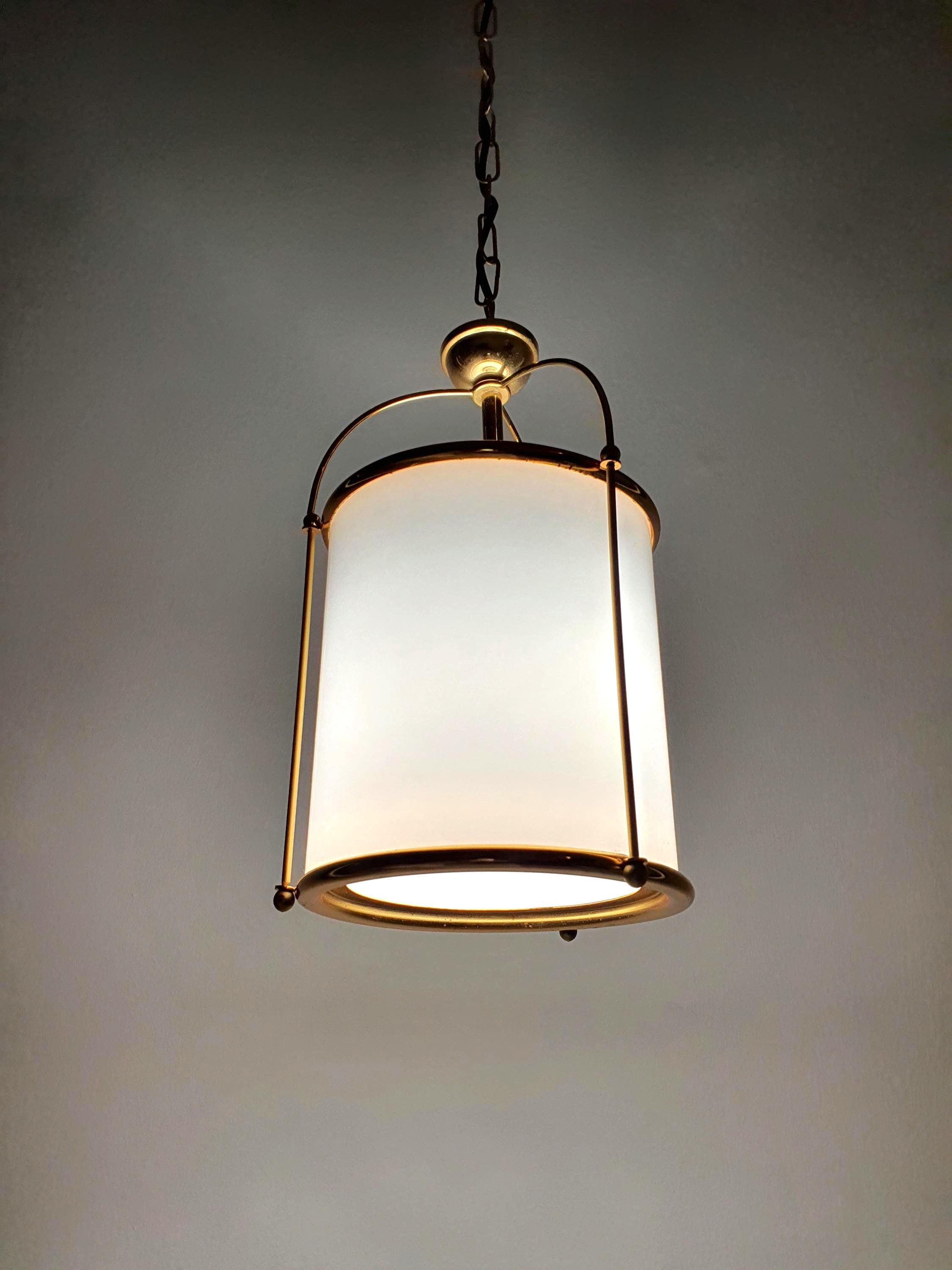 Milk glass pendant light with gold metal cage frame